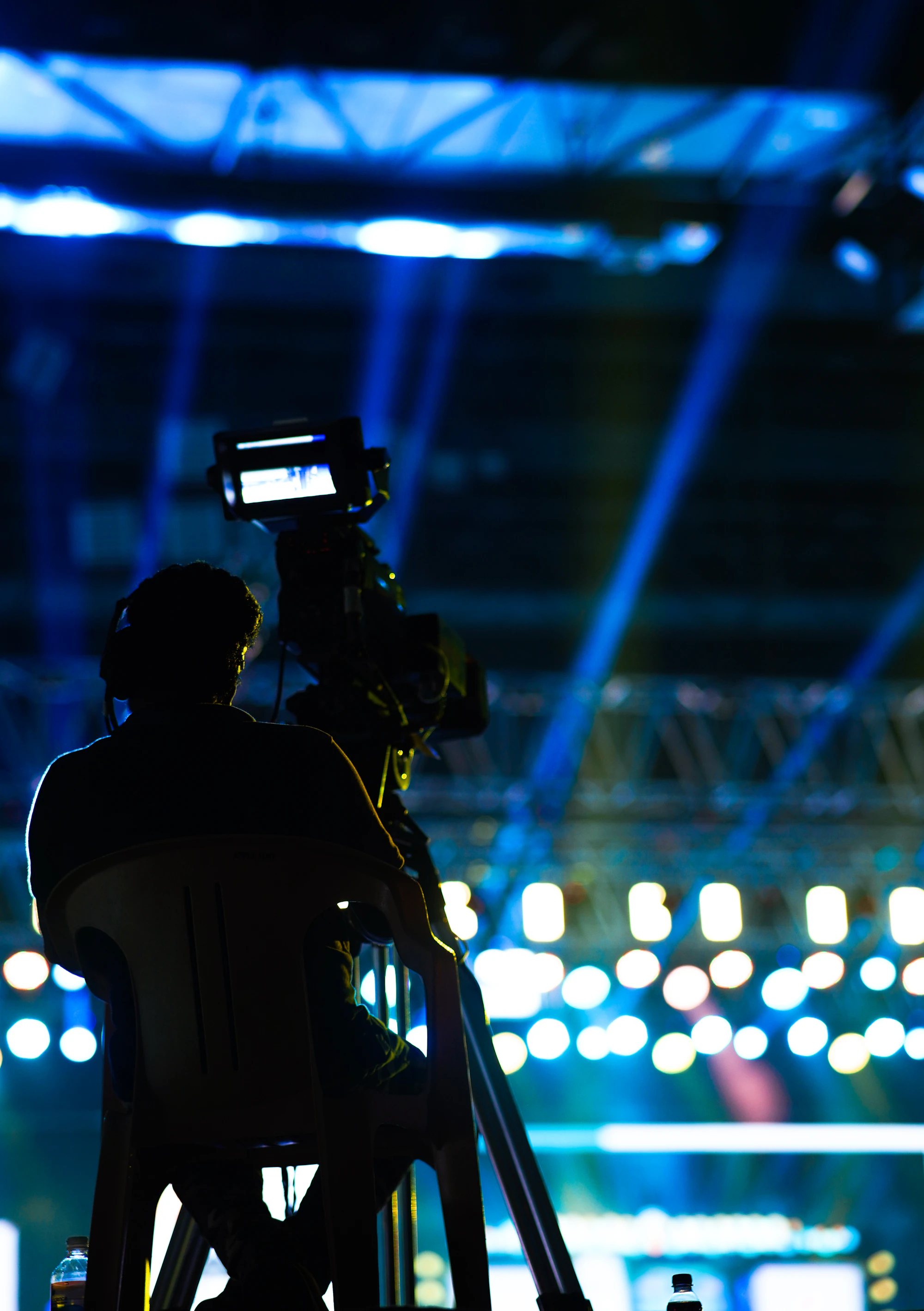 A videographer filming an event with a professional camera
