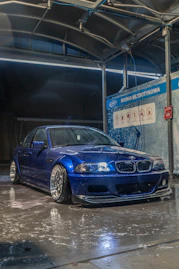 Blue BMW sedan at a self-service car wash