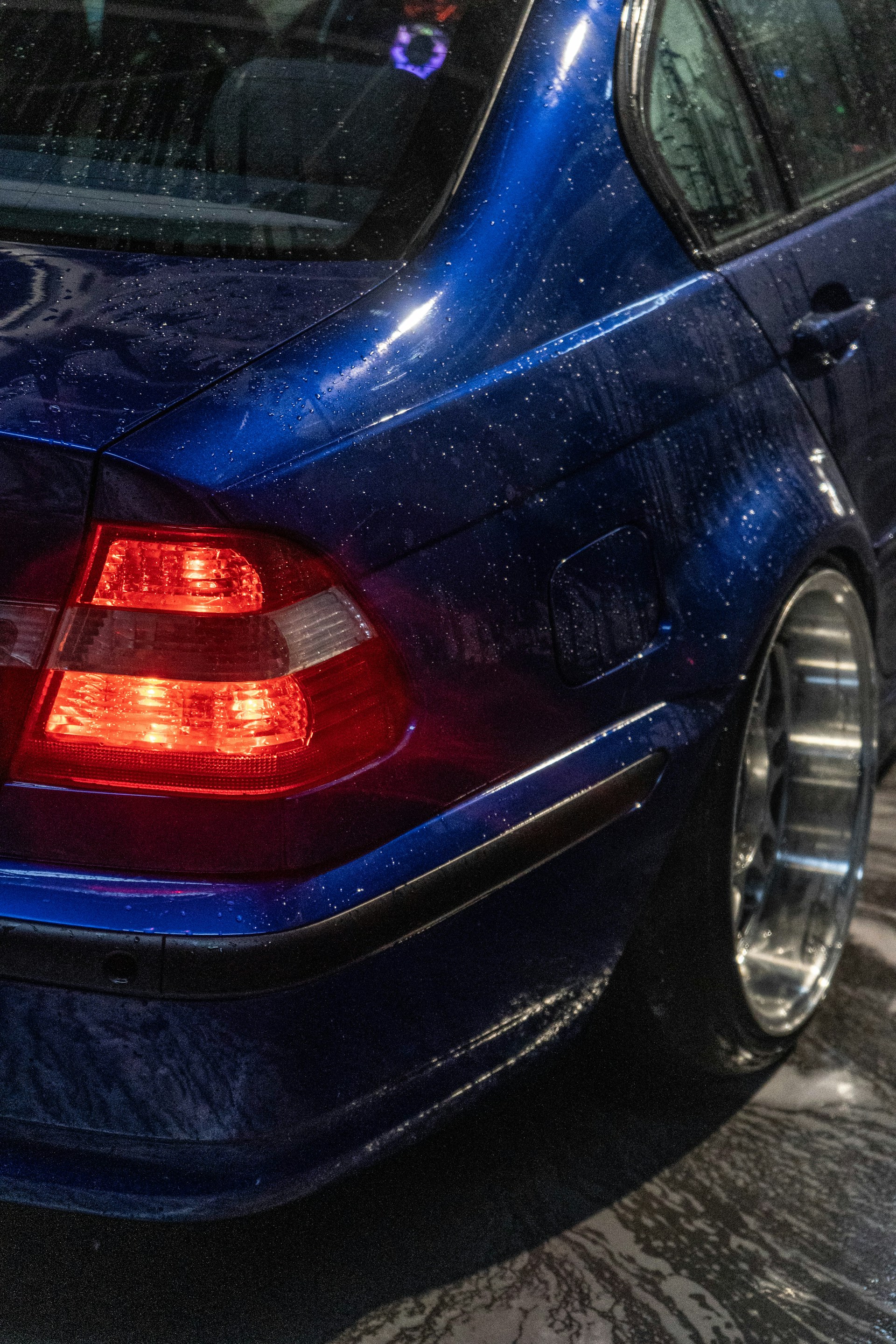 Wet blue car with chrome wheels