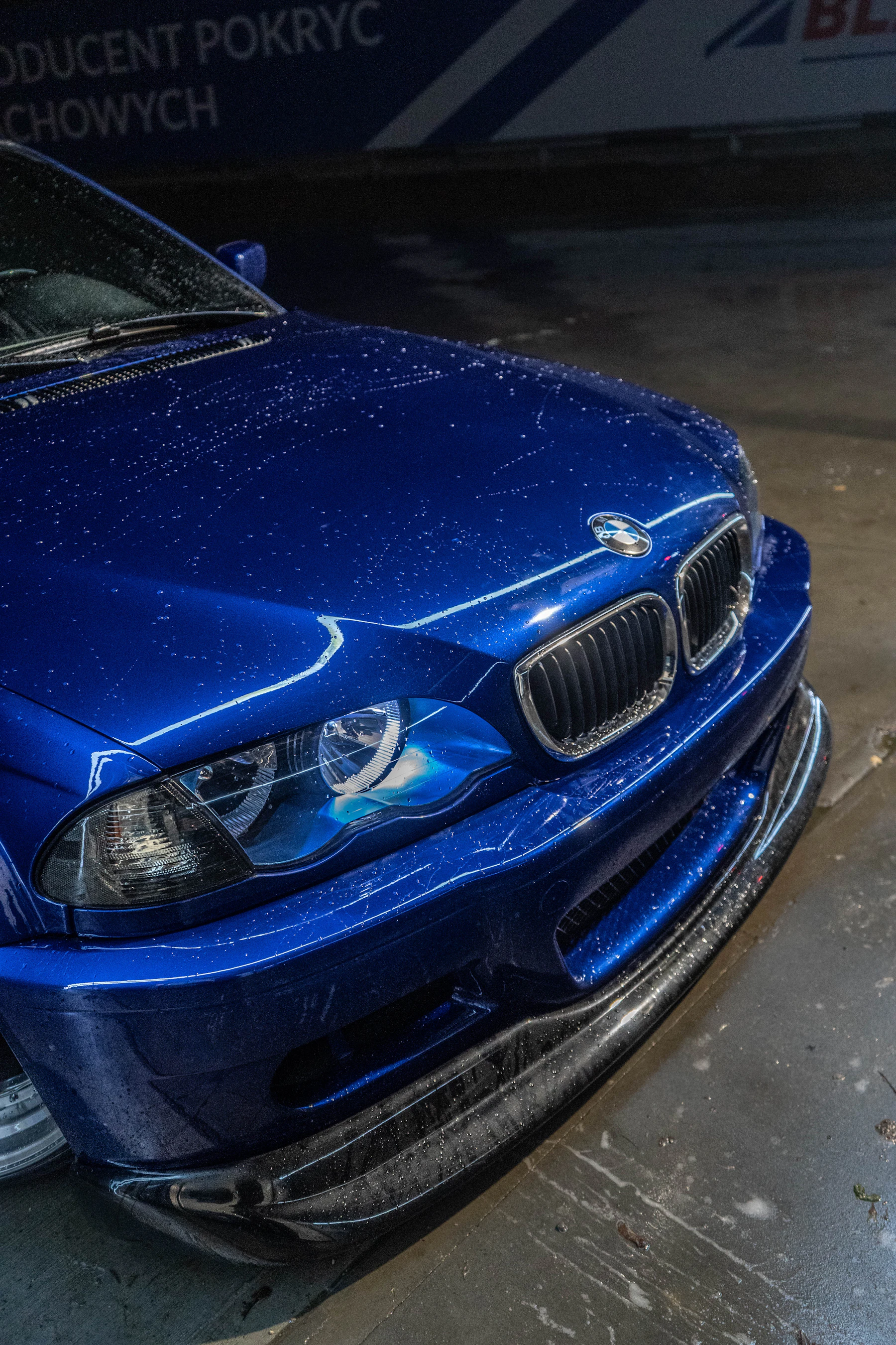 Clean shiny car with water droplets after wash