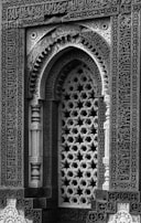 Intricate islamic architecture with geometric lattice window.
