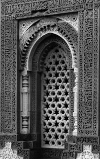 Intricate islamic architecture with geometric lattice window.