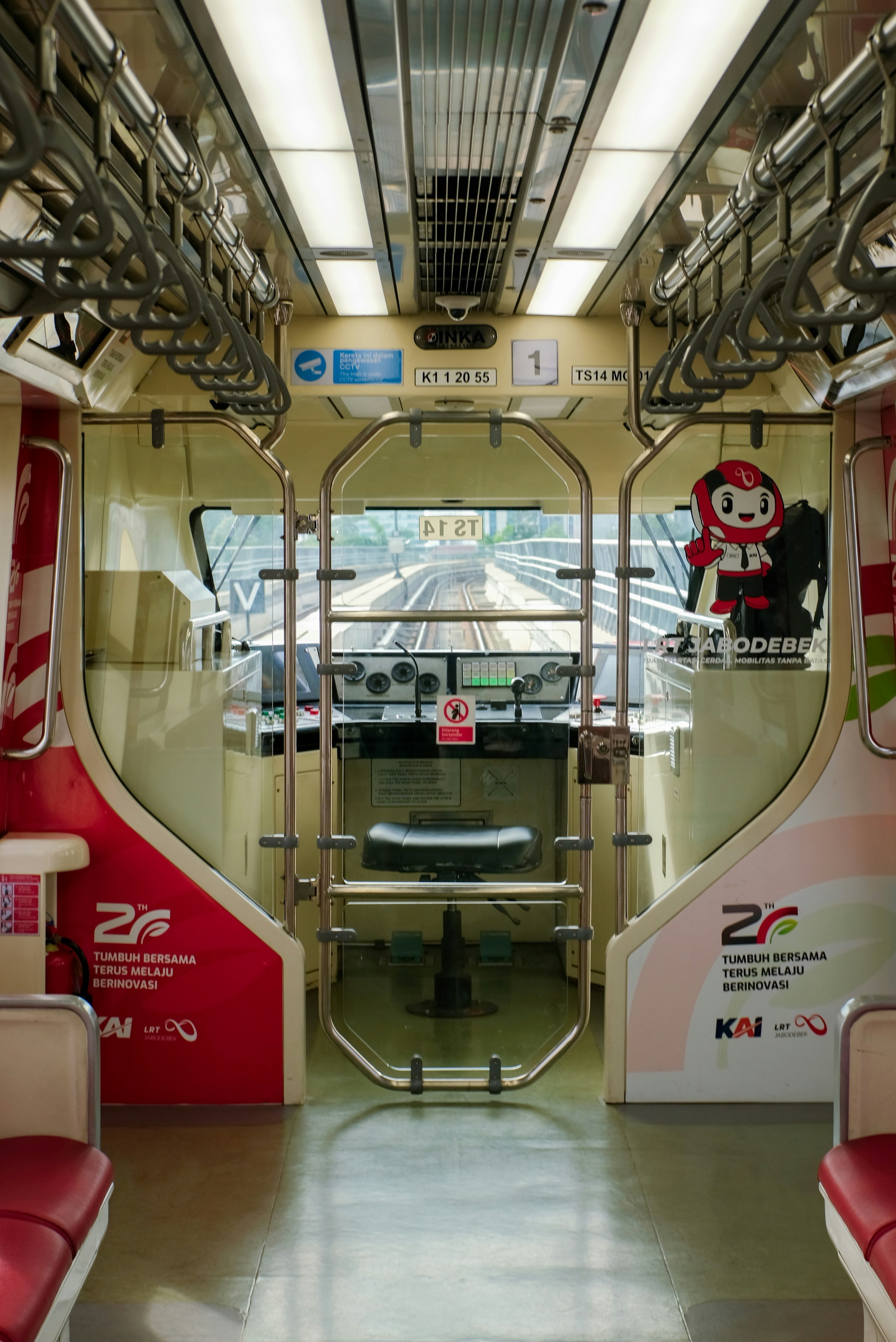Inside view of a train cabin with tracks ahead tracks