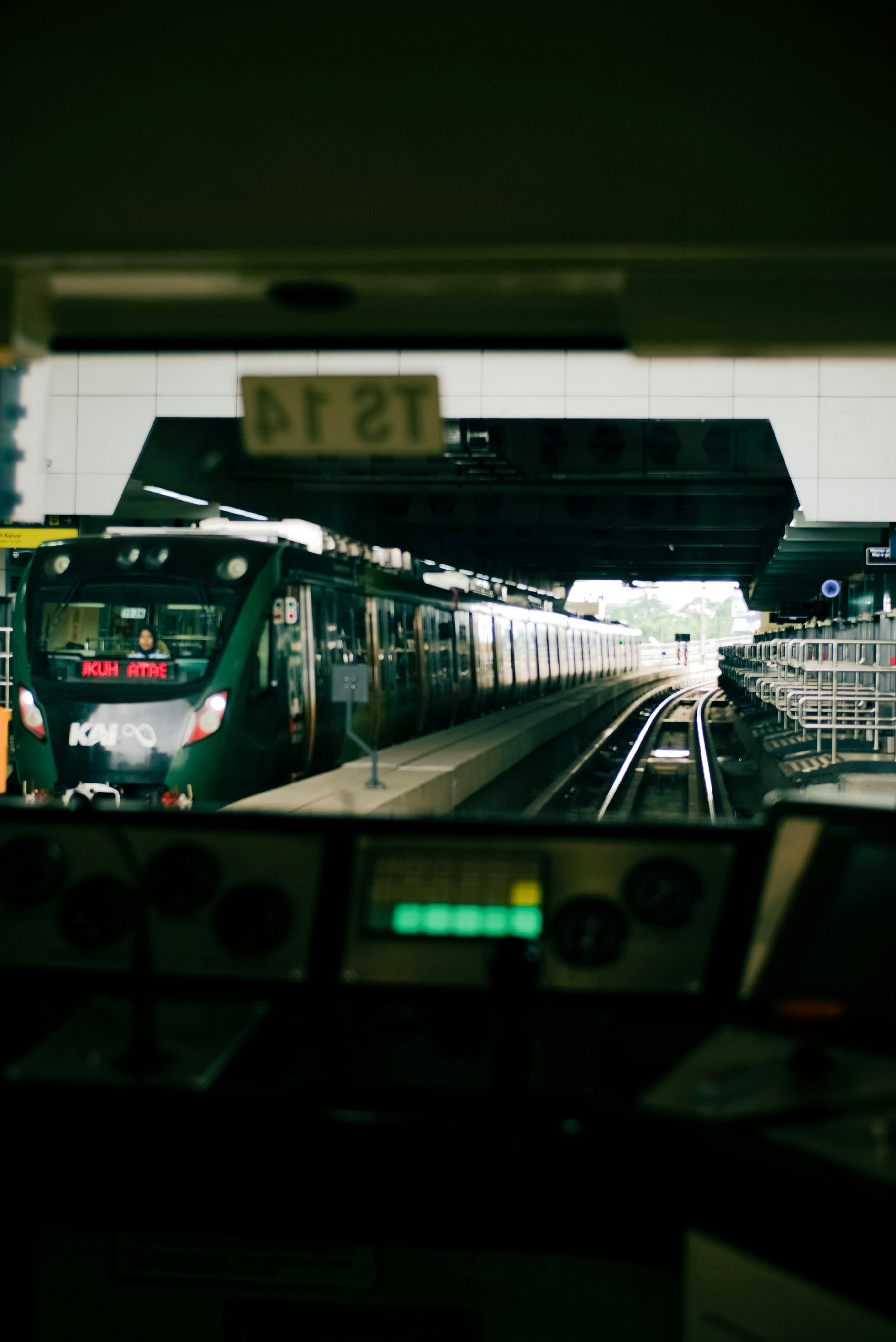 Green train at a station platform