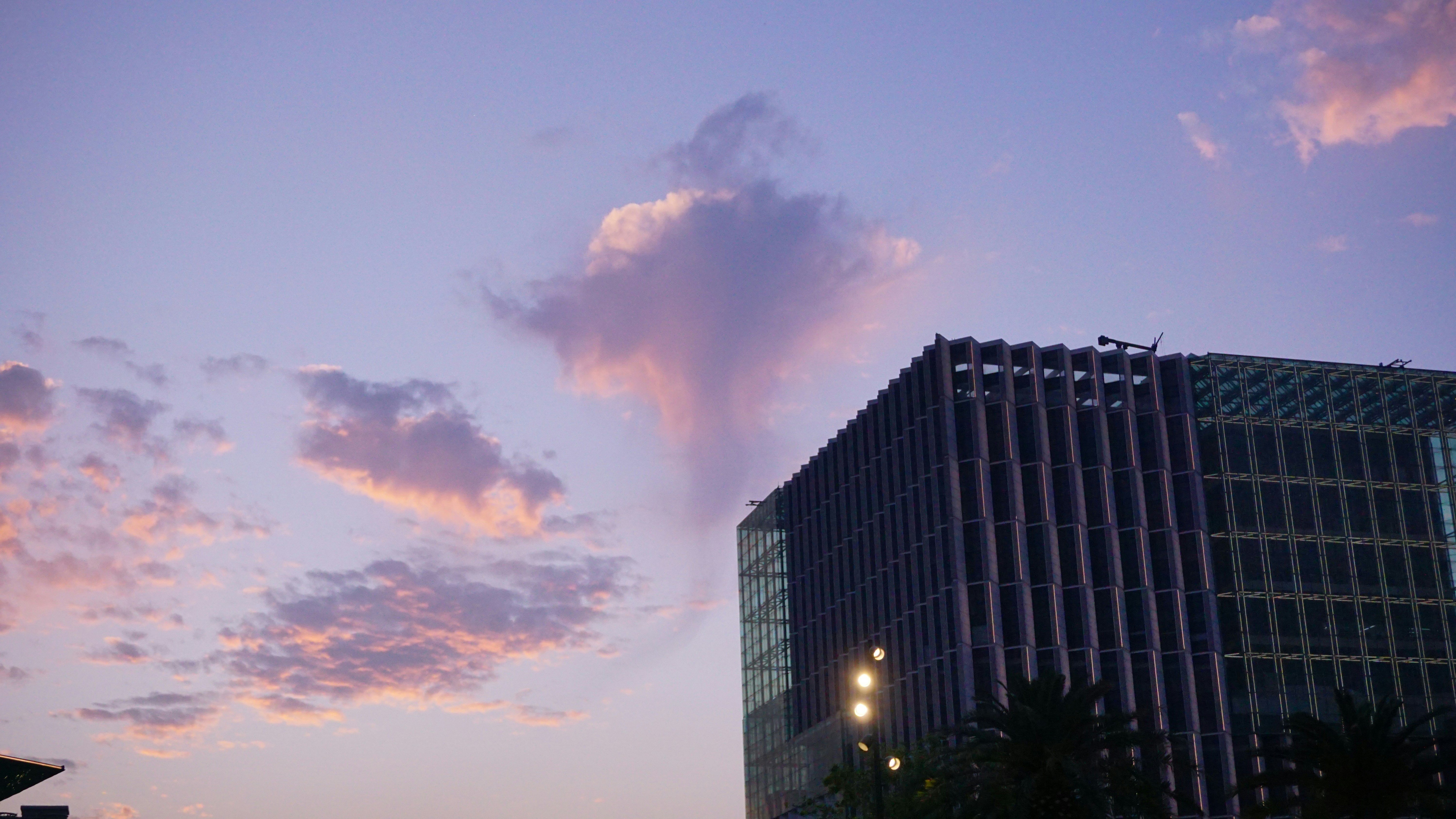 Modern building against a purple sunset sky.