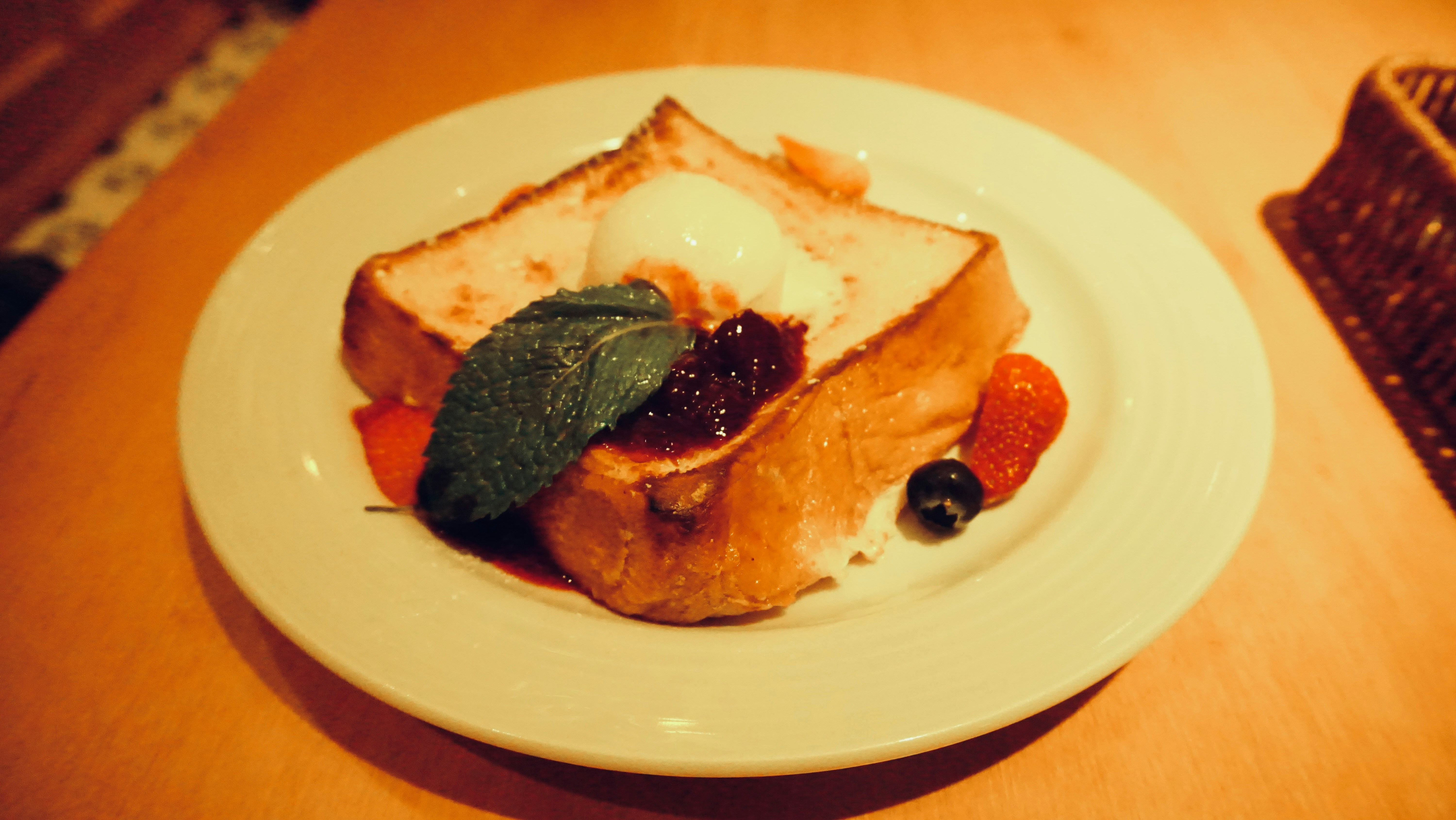 French toast with berries and cream on plate