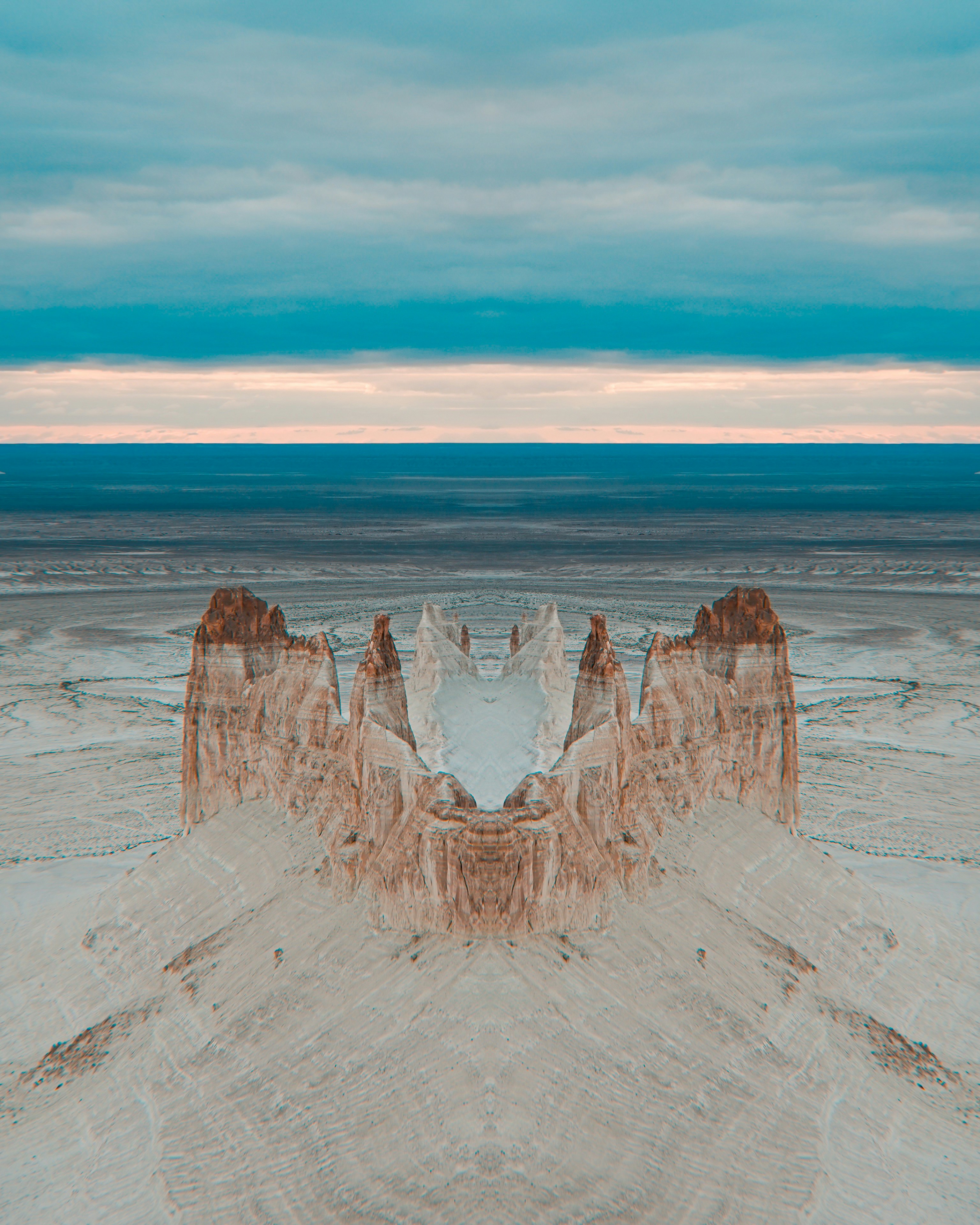 Symmetrical desert landscape with rock formations and sky