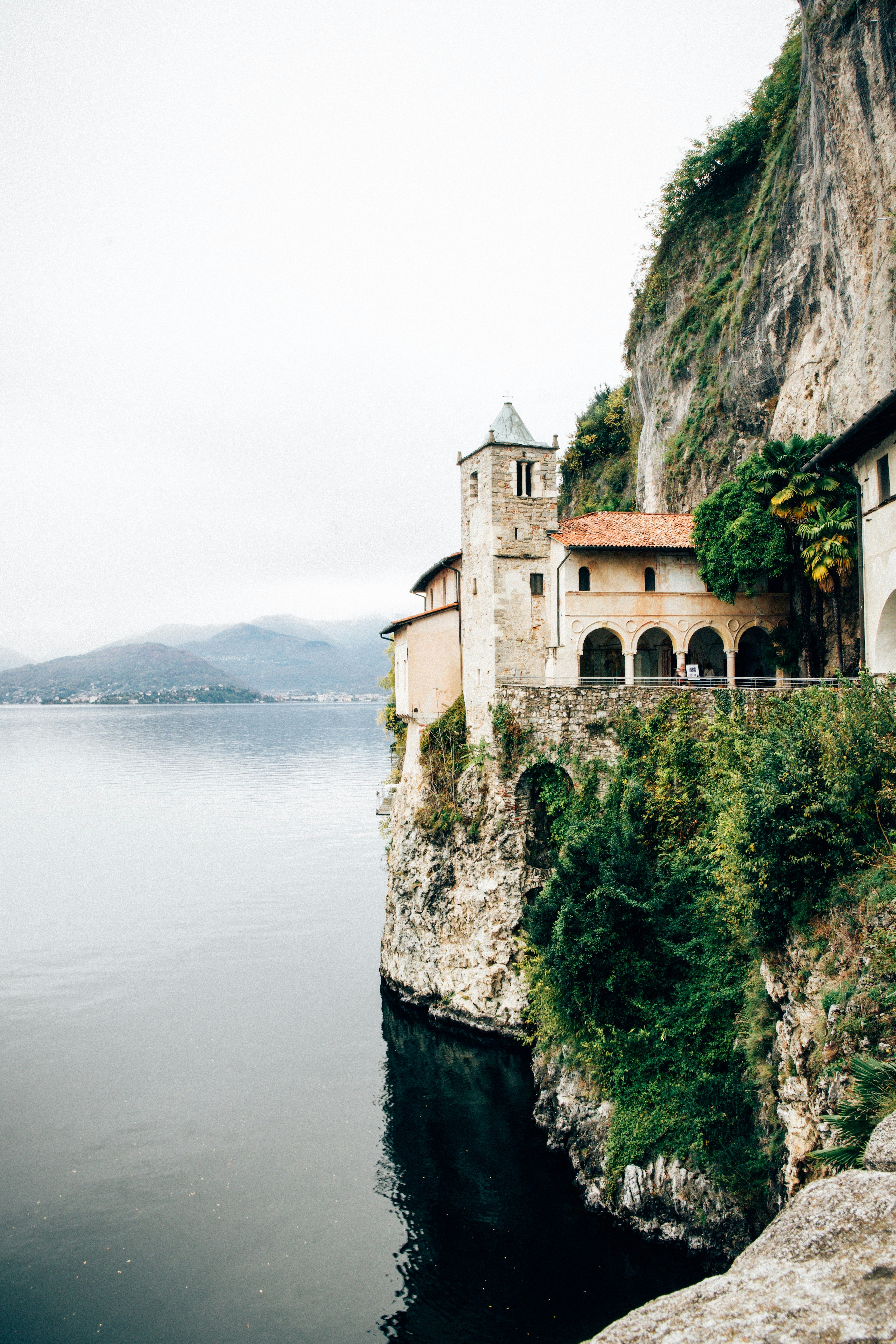 Monastery built into a cliffside overlooking a lake