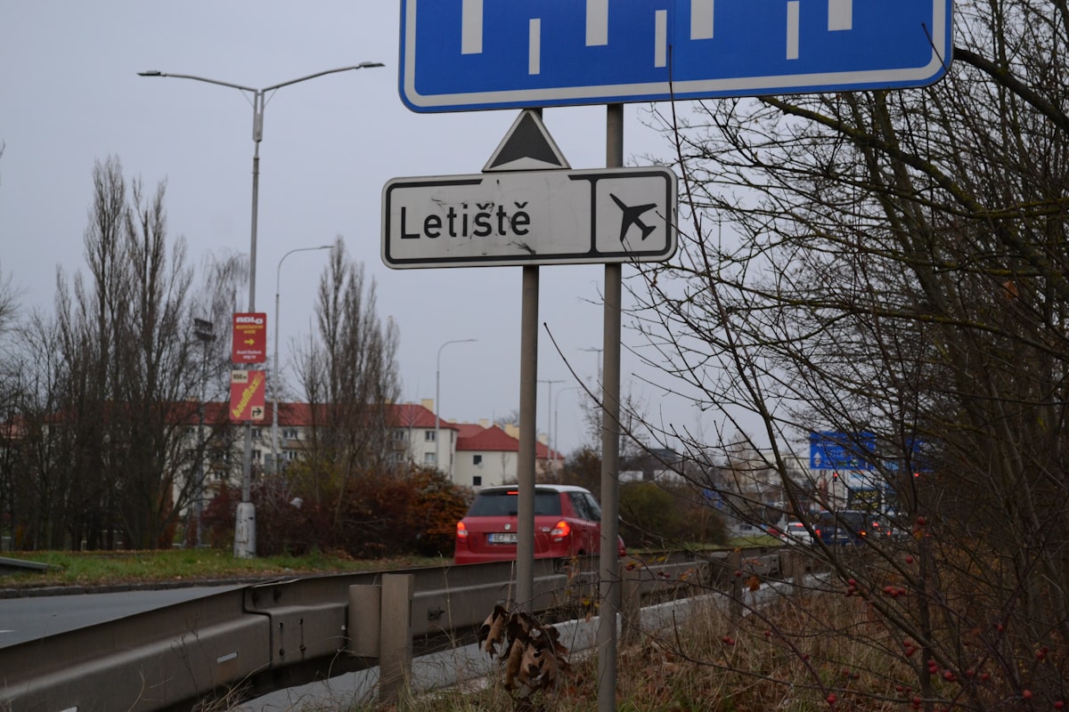 Sign for letiště airport with airplane symbol.