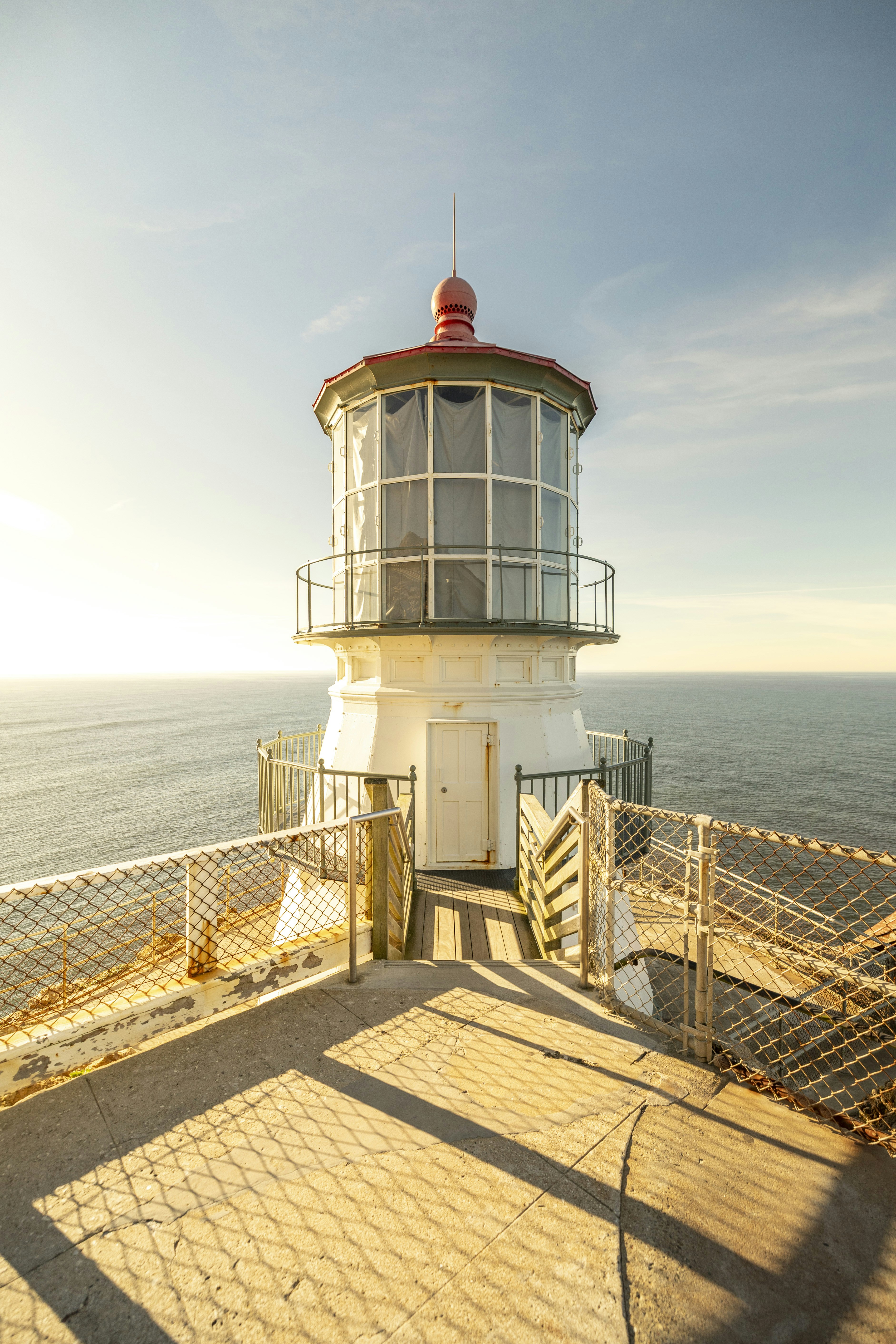 Lighthouse overlooking the ocean at sunset