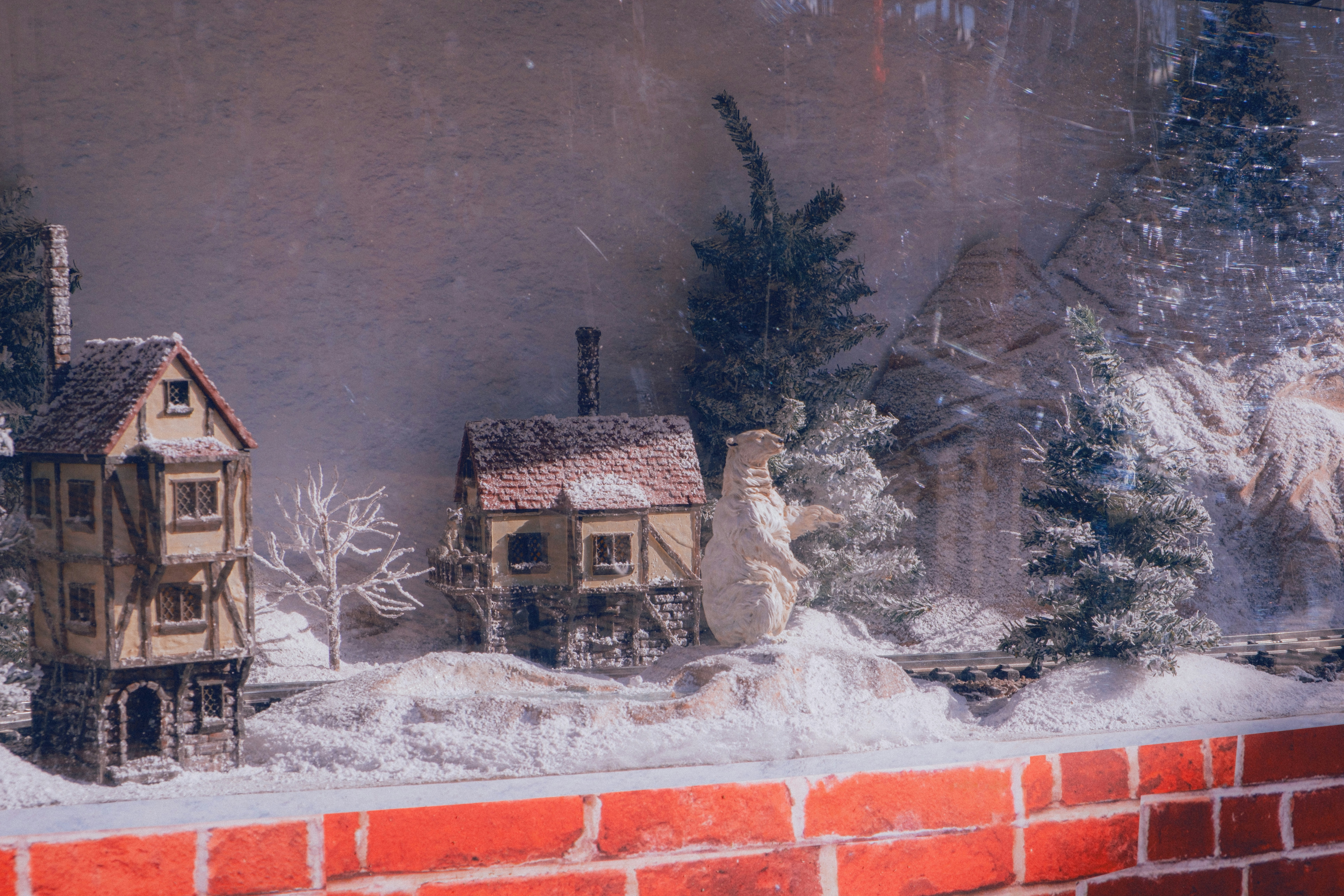 Miniature winter village scene with snow covered houses.