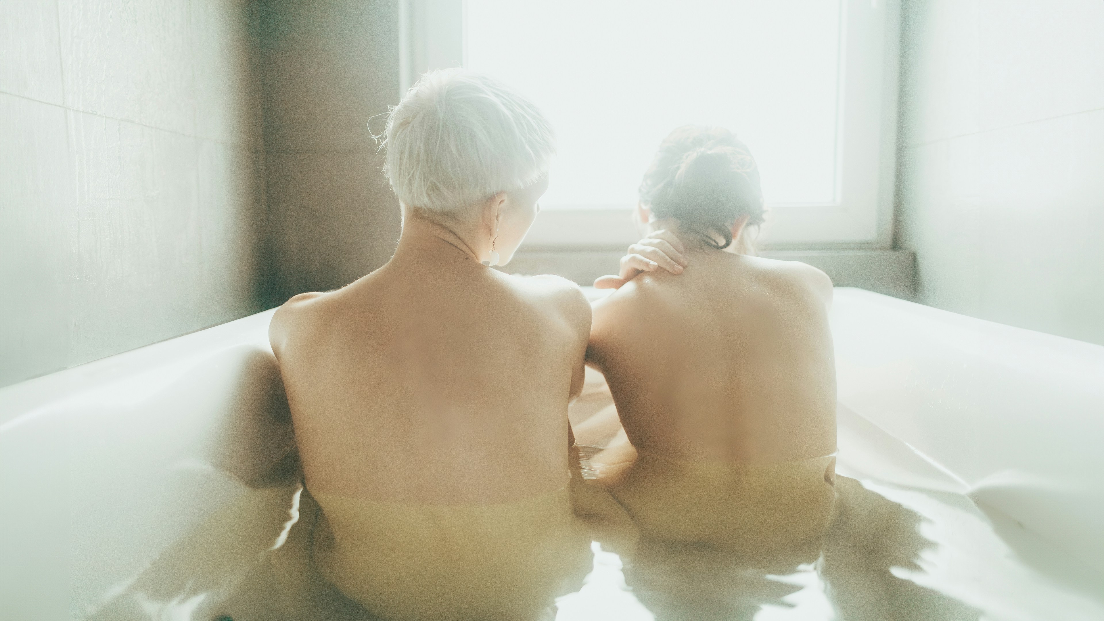 Two people relaxing in a bathtub