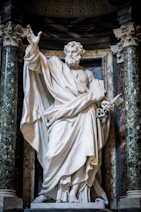 Marble statue of a bearded man holding keys.