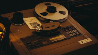 Vintage reel-to-reel tape recorder with a spool of tape.