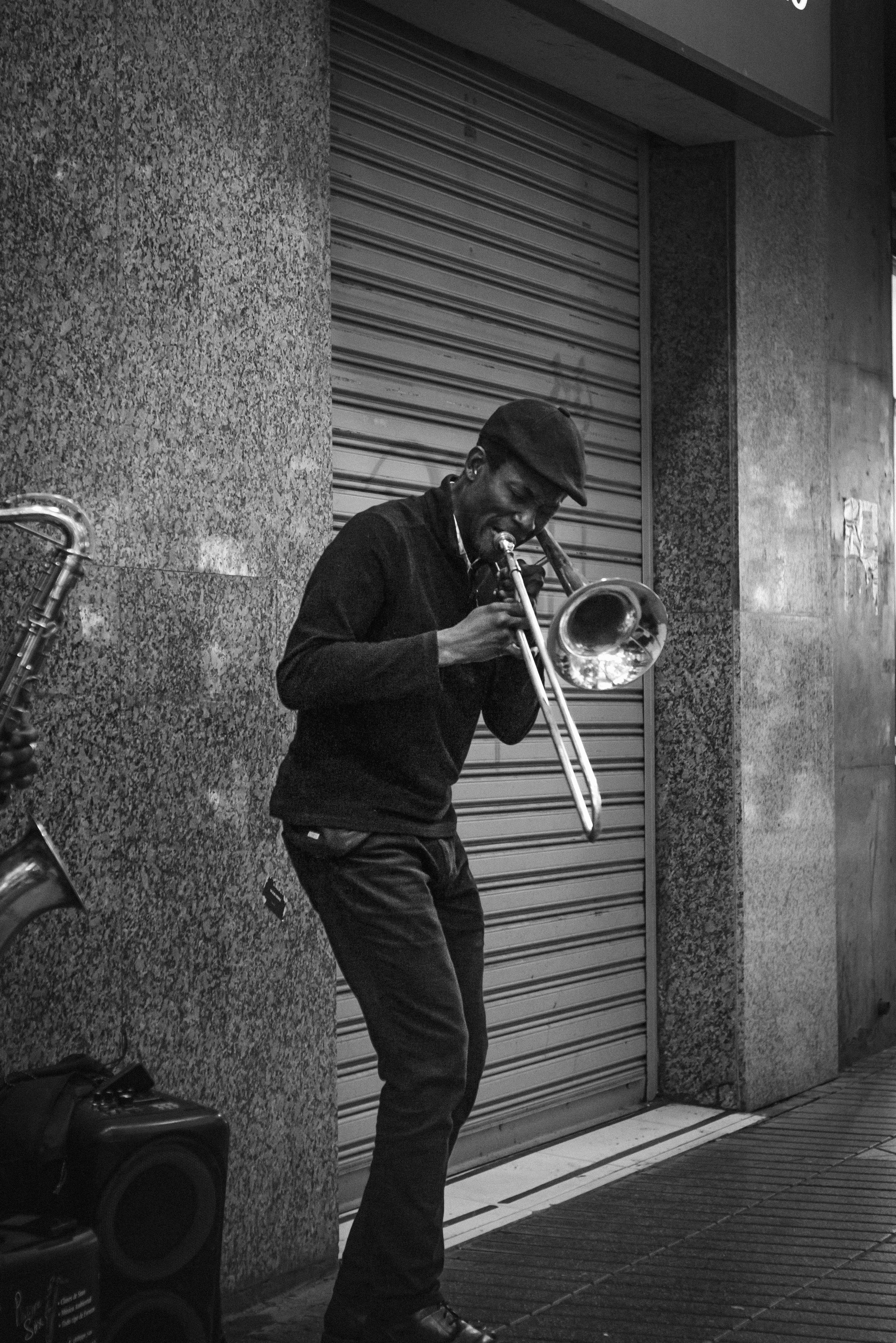Man playing trombone on a city street