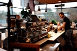 Barista preparing drinks behind a coffee machine