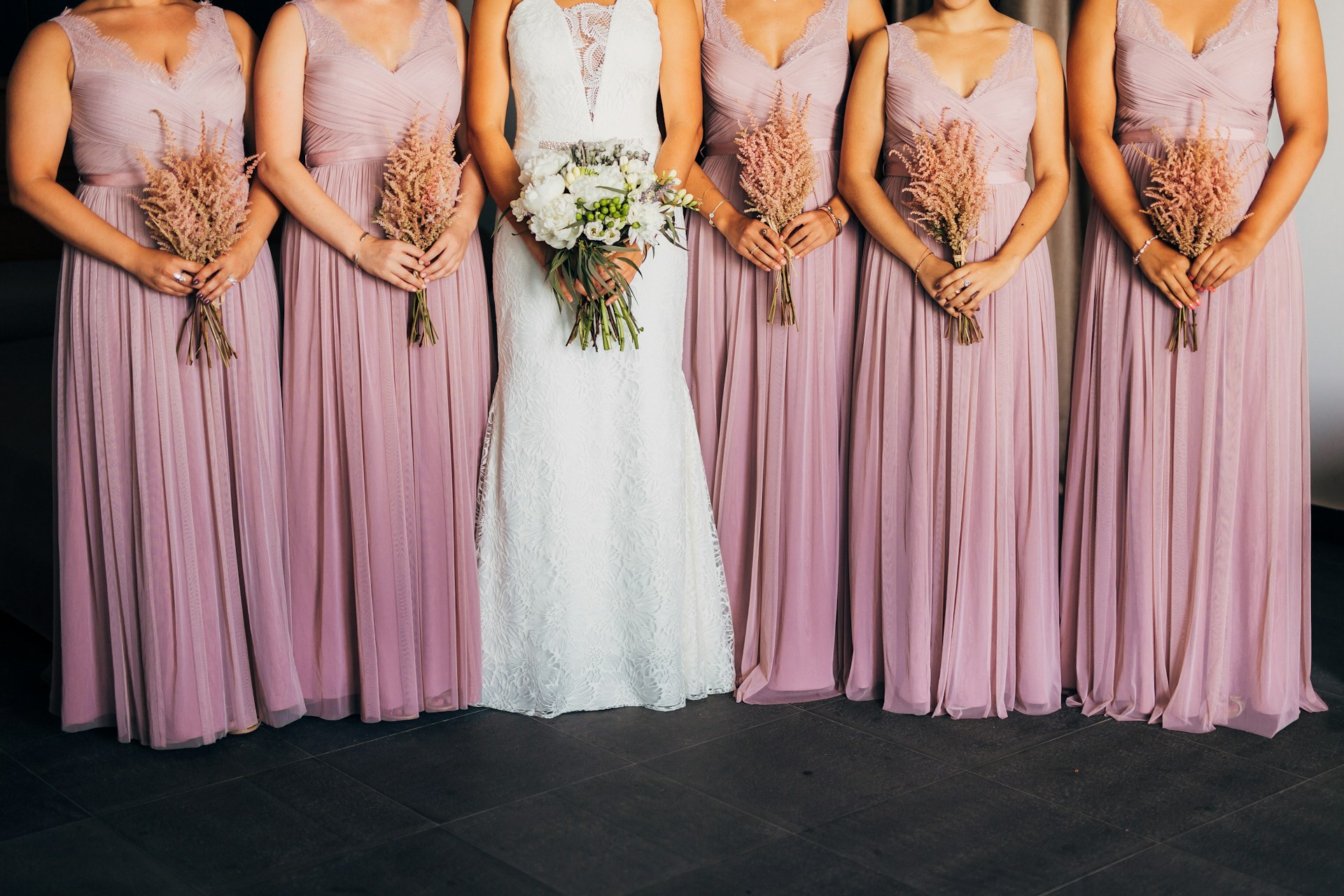 Bride and bridesmaids holding bouquets