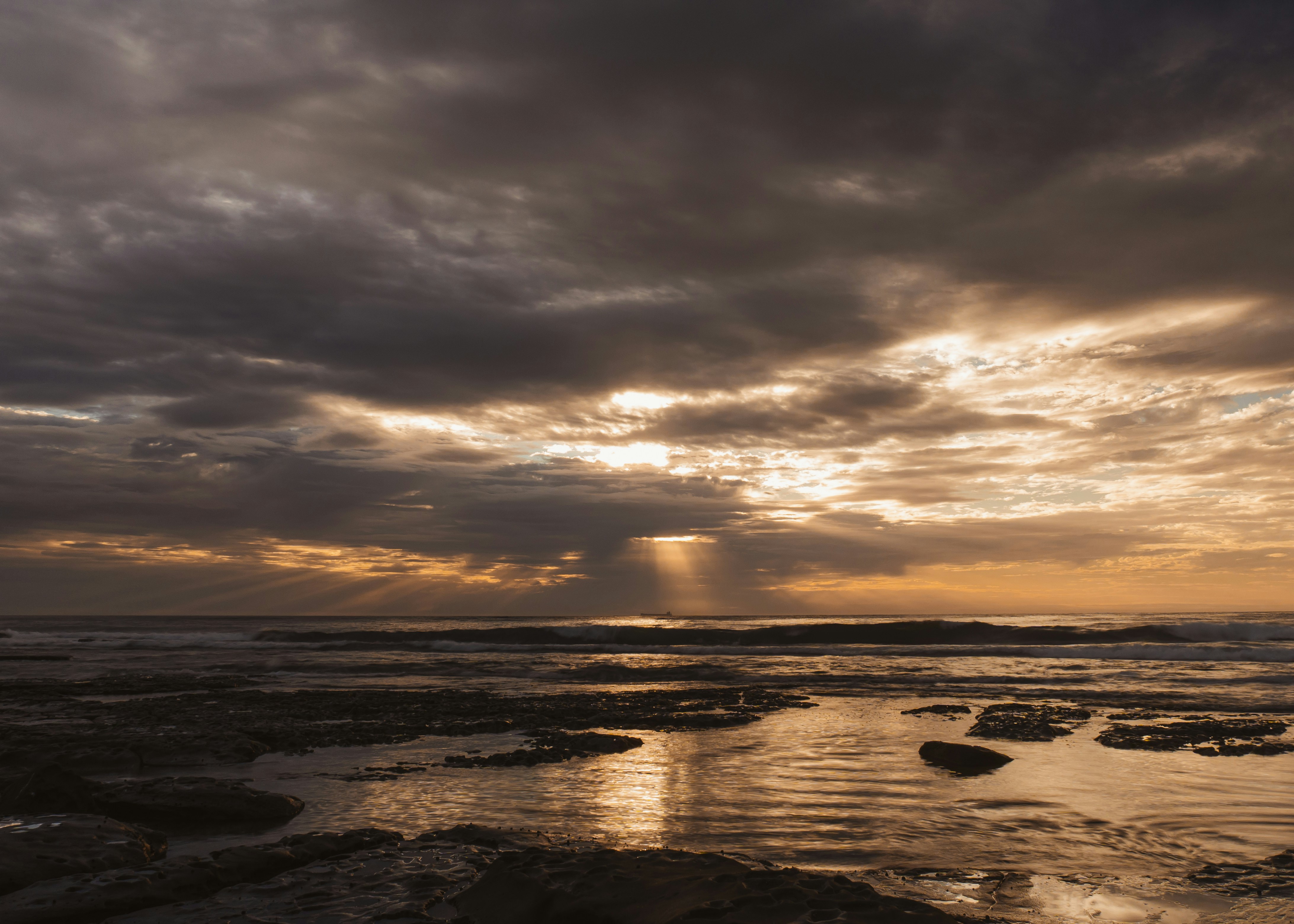 Dramatic sunset over the ocean with light rays.