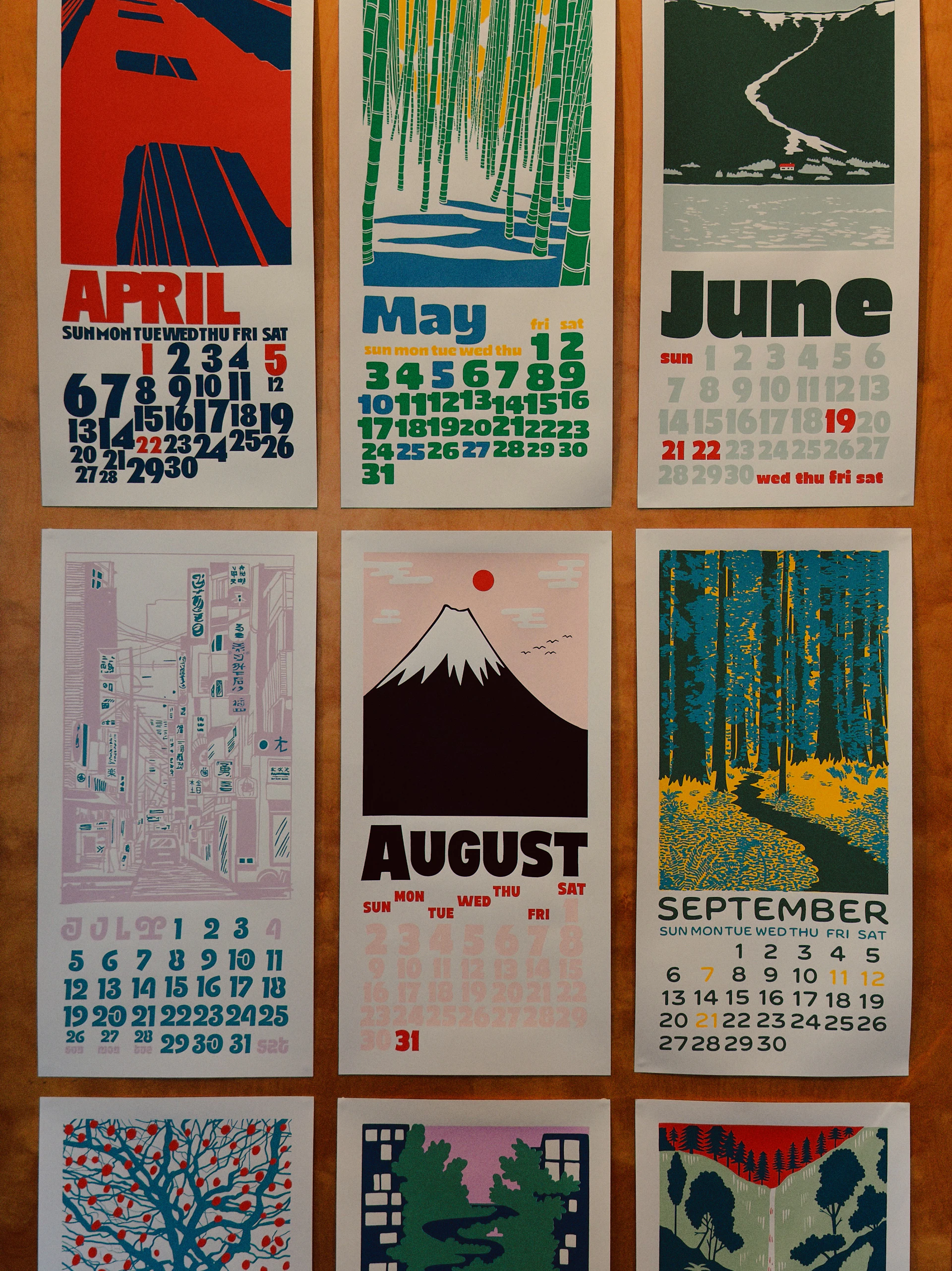 Calendar pages with artistic monthly illustrations.
