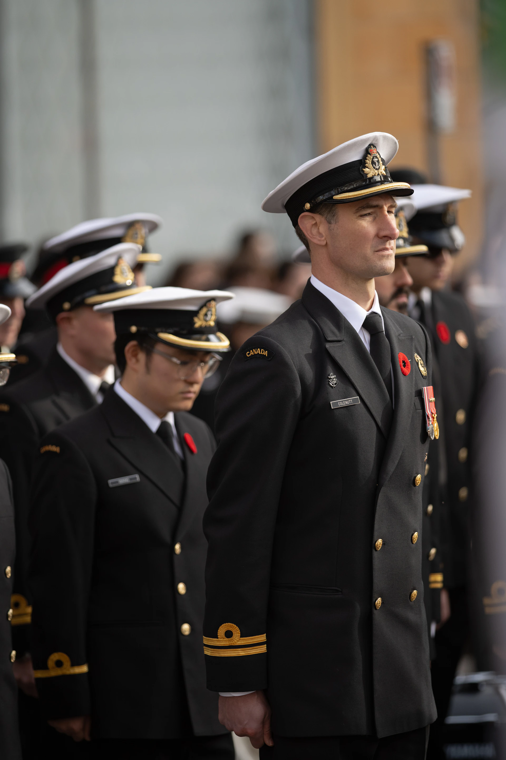 Men in naval uniforms with poppies