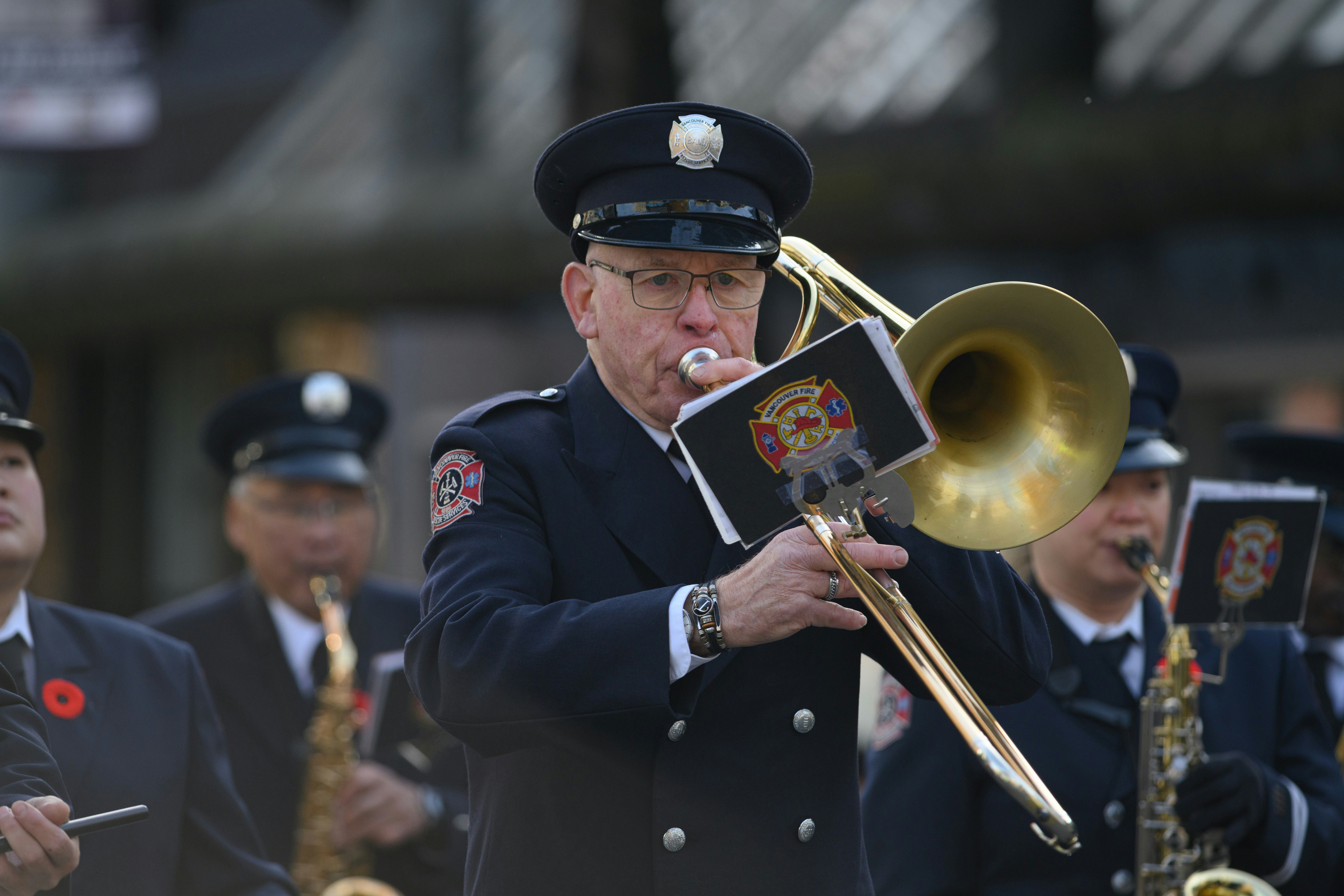 Firefighter plays trombone in a marching band.