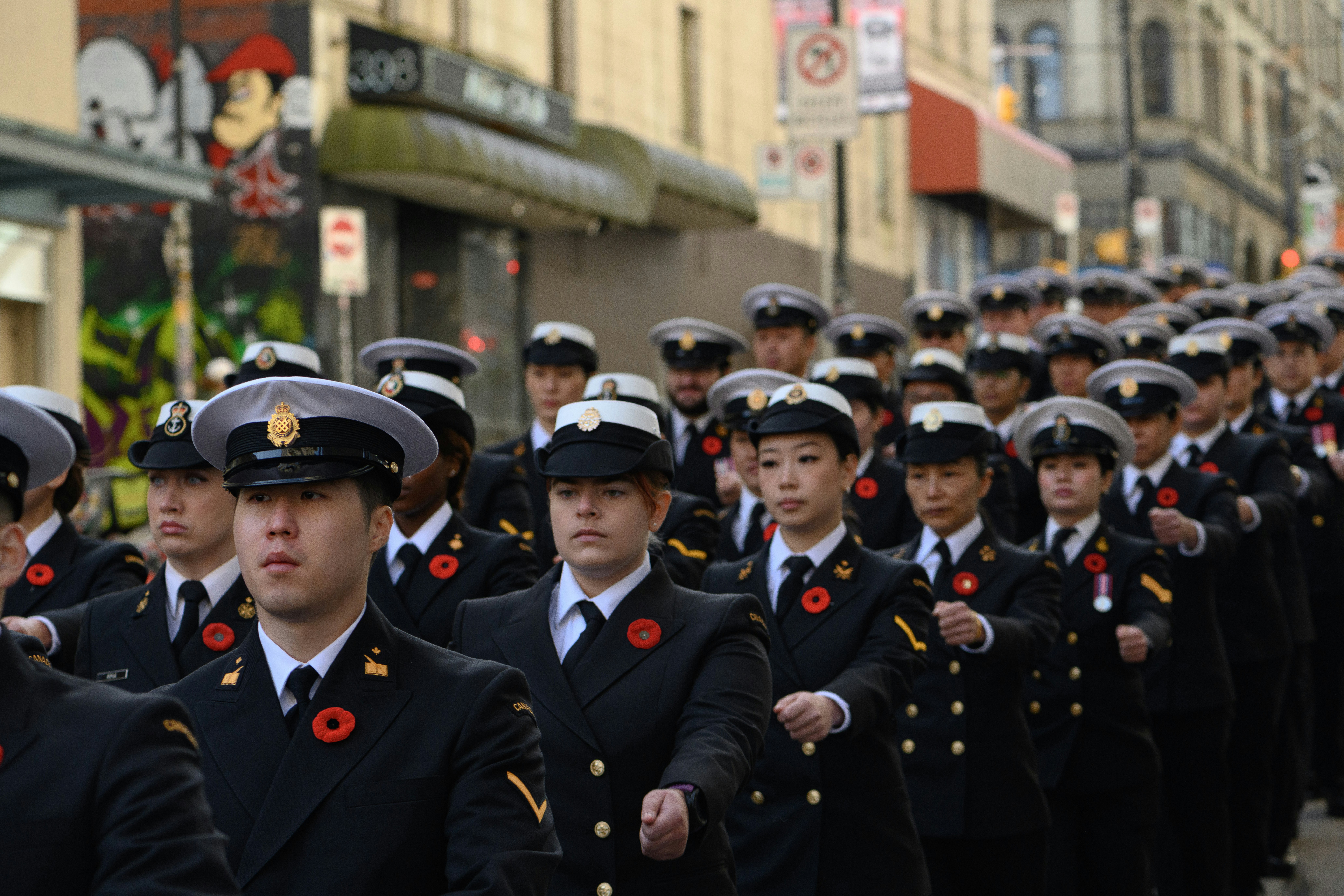 A group of people in uniform marching in formation.