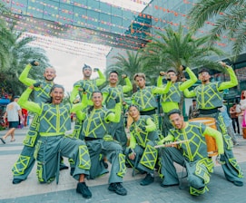 Group of performers in neon green and gray outfits
