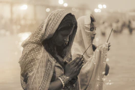 Two women praying with incense sticks