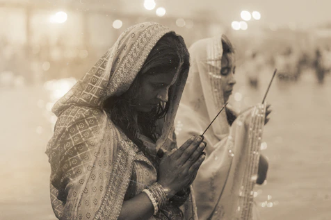 Two women praying with incense sticks