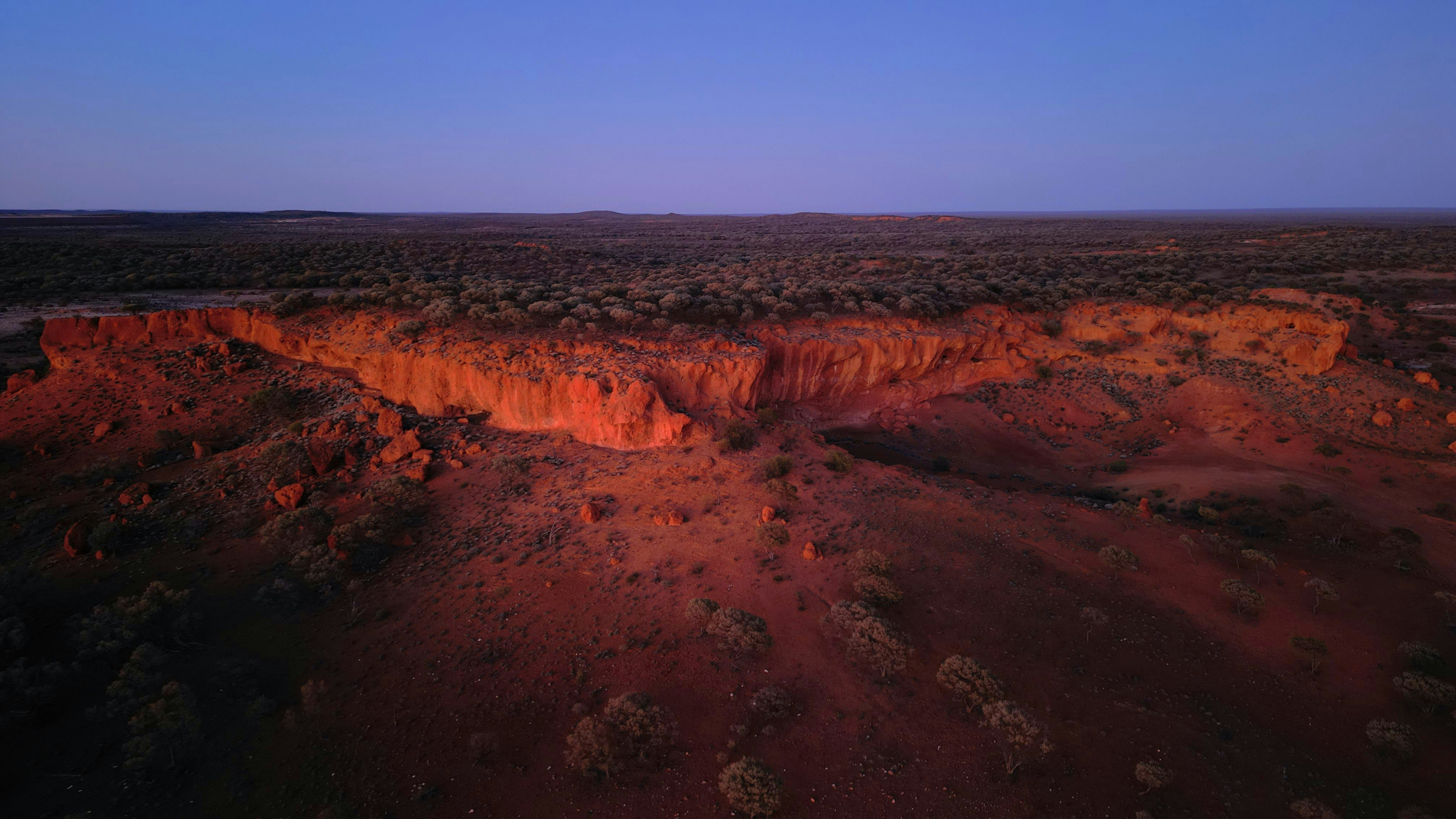 Red rock formations under a twilight sky