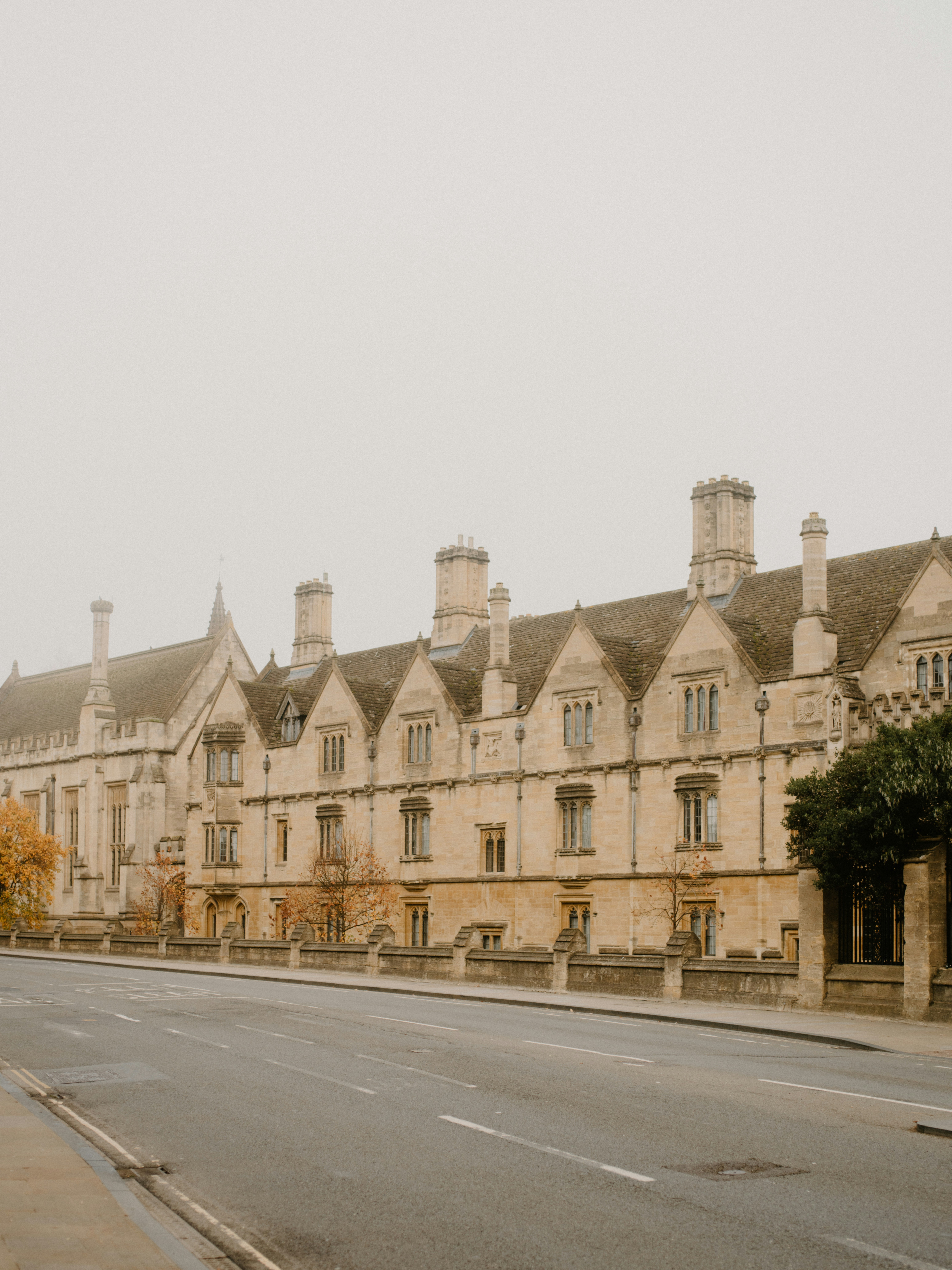 Historic stone building with ornate windows and chimneys.