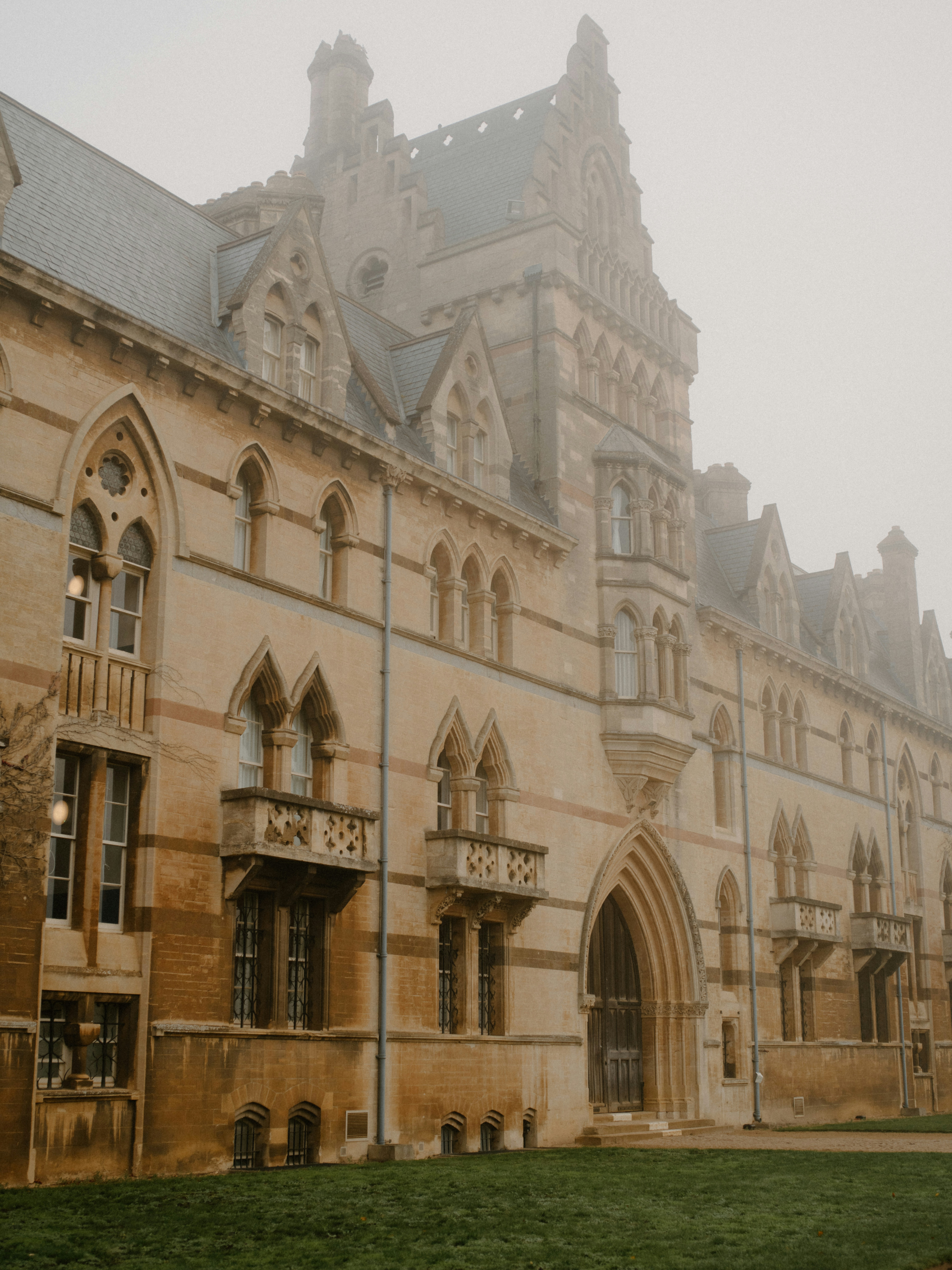 Historic stone building shrouded in fog
