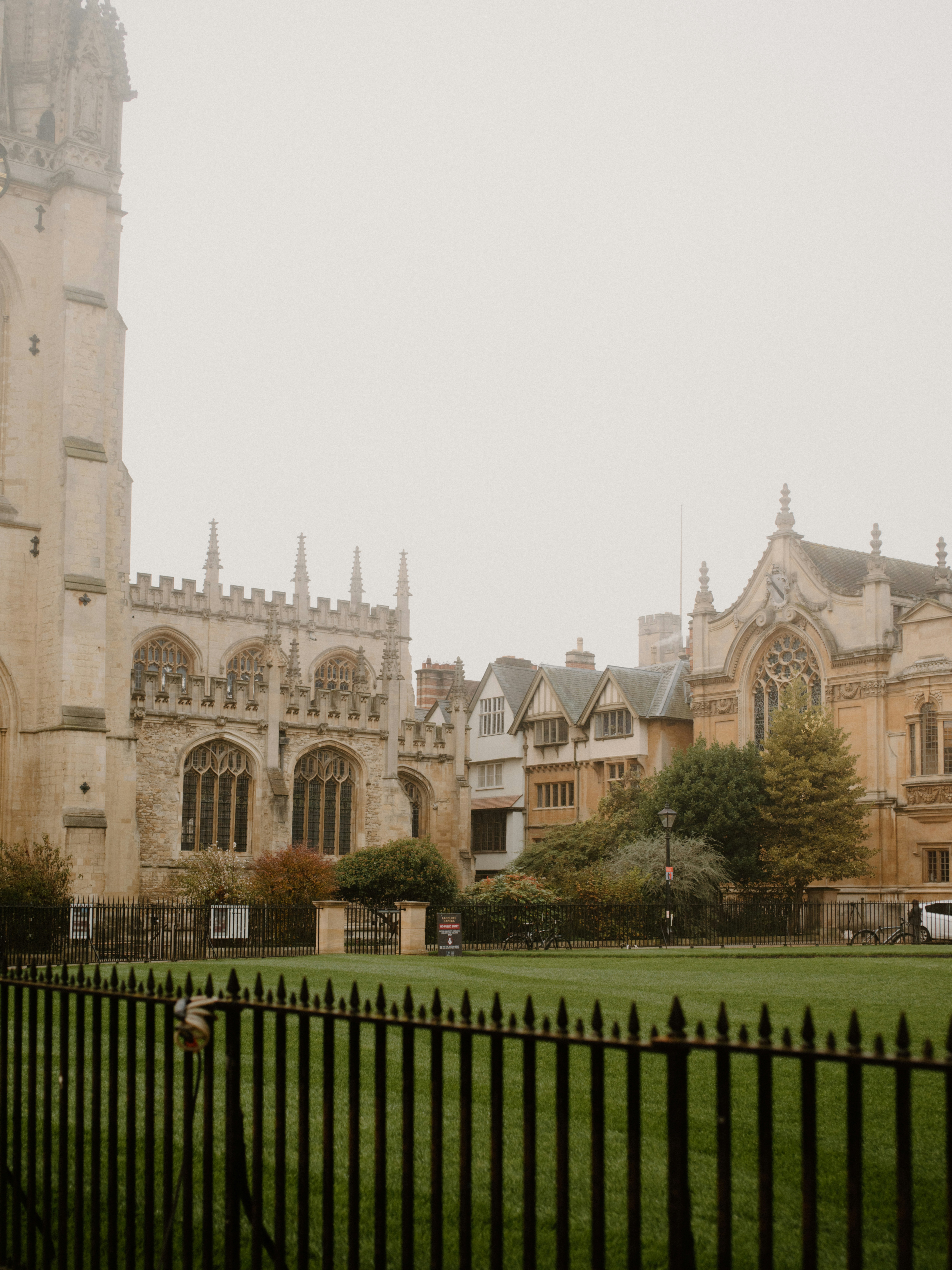 Historic buildings and green lawn on a foggy day