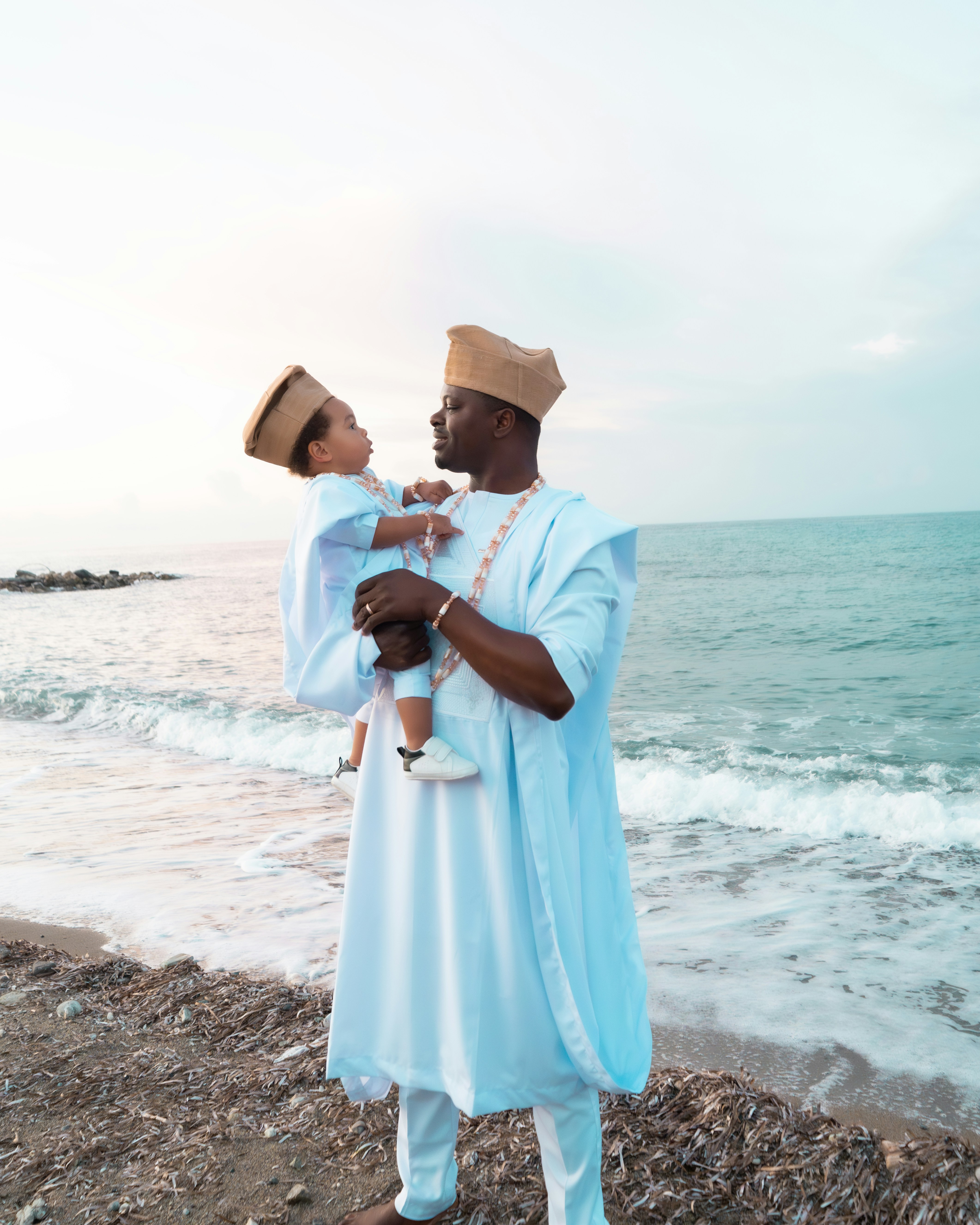 Father and son in matching outfits by the sea