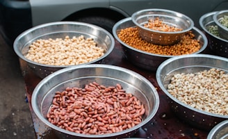 Bowls of assorted dried beans and legumes.