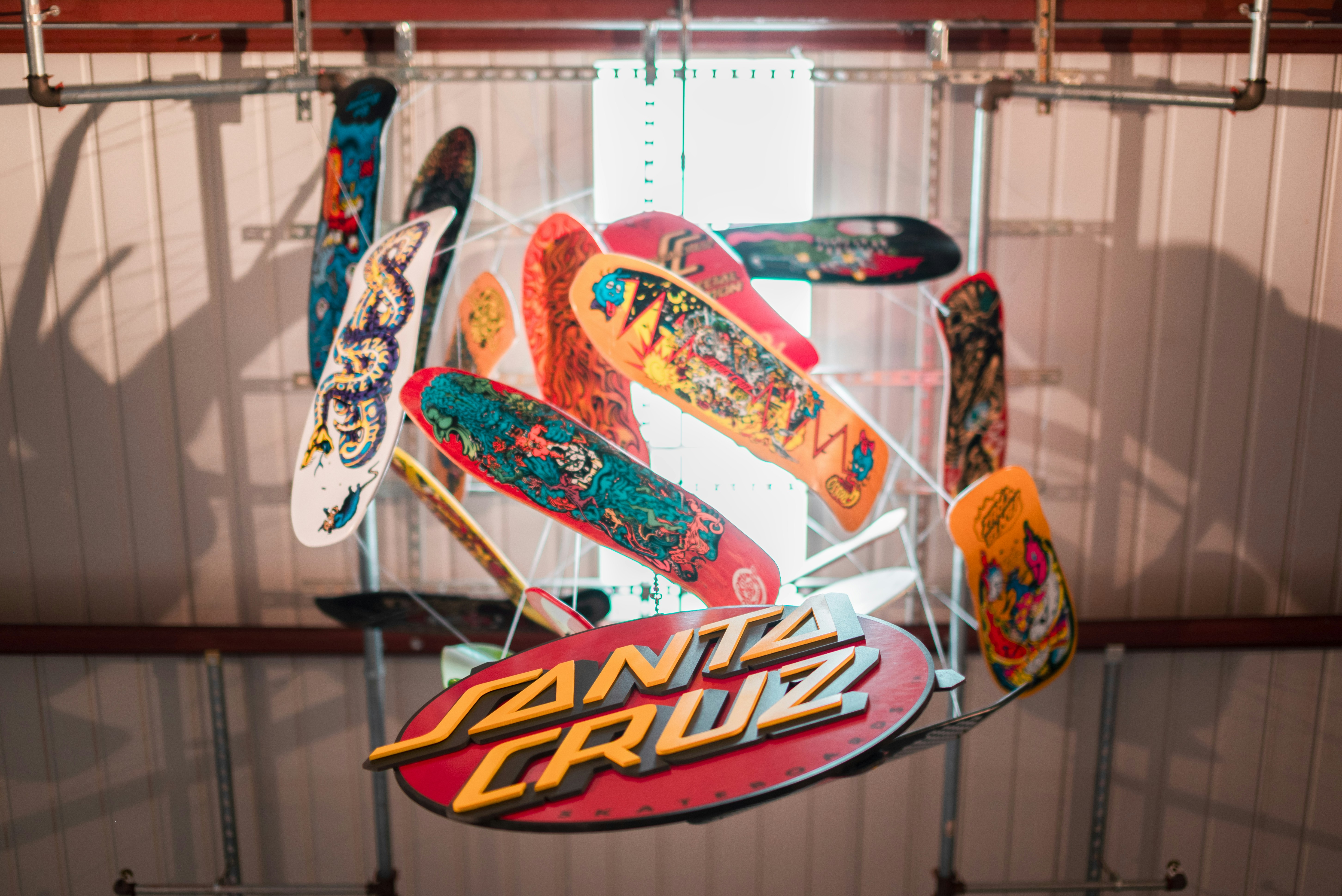 Assortment of colorful skateboards hanging indoors