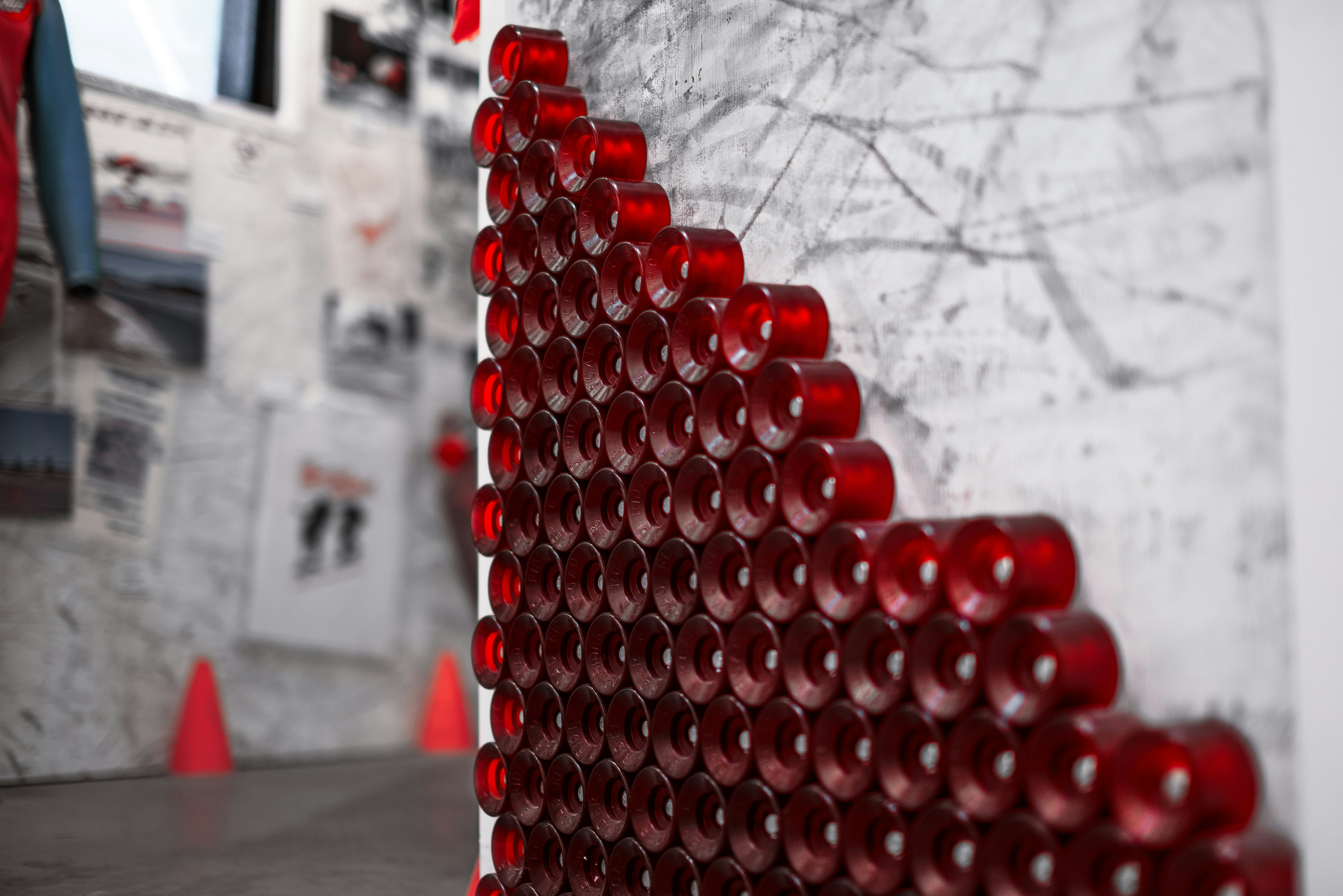 Red circular objects arranged on a wall