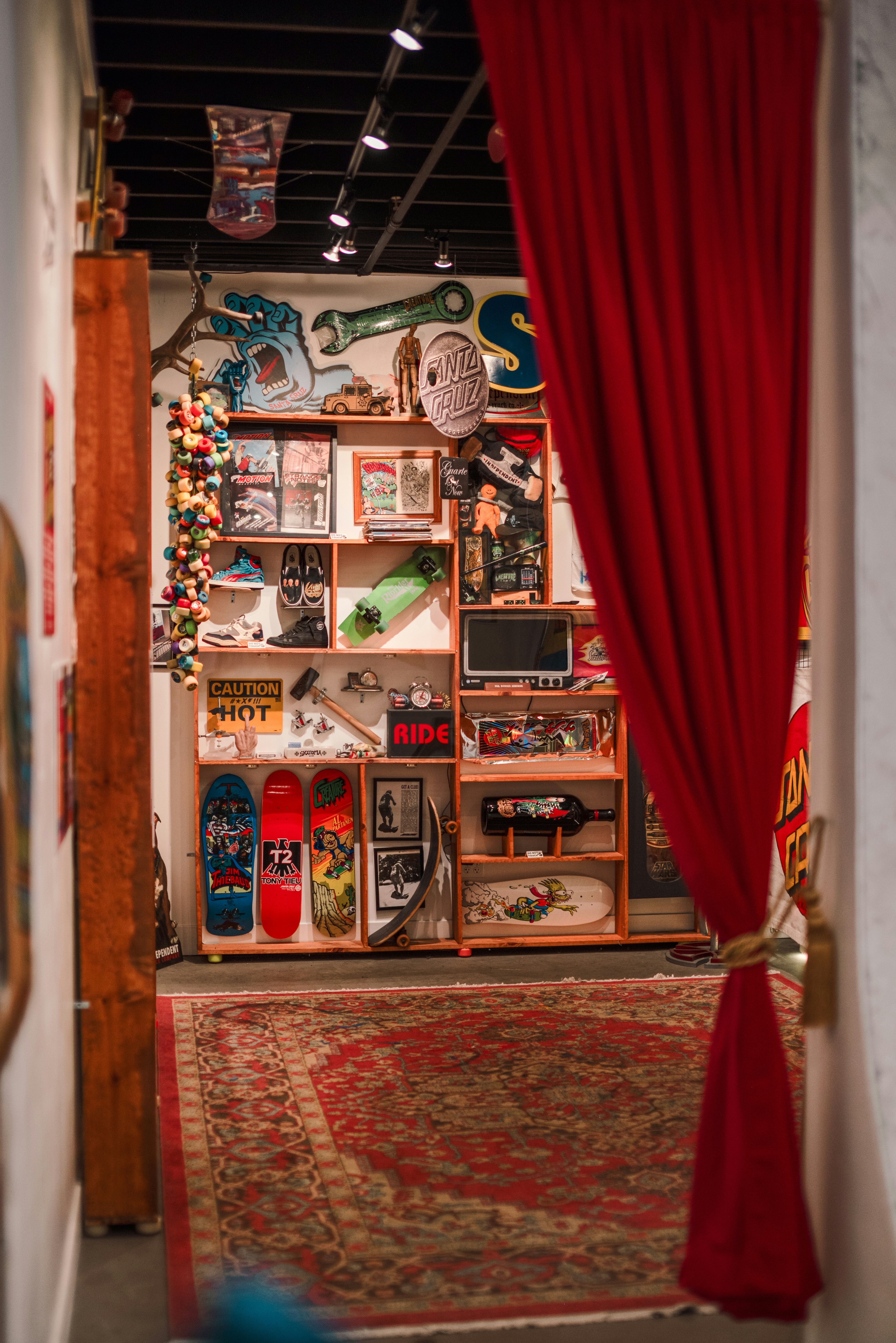 Skateboards displayed on shelves in a room