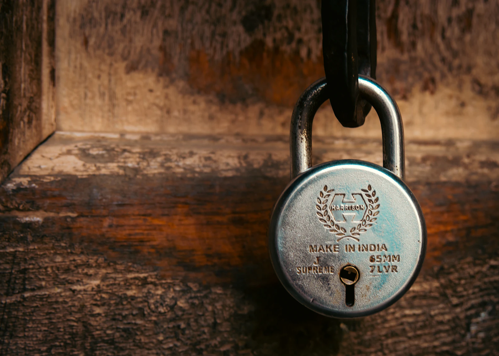 A vintage padlock hanging on a wooden door, representing a signal Google has locked away and no longer opens for, the way rel="next" and rel="prev" now sit inert in a page's markup