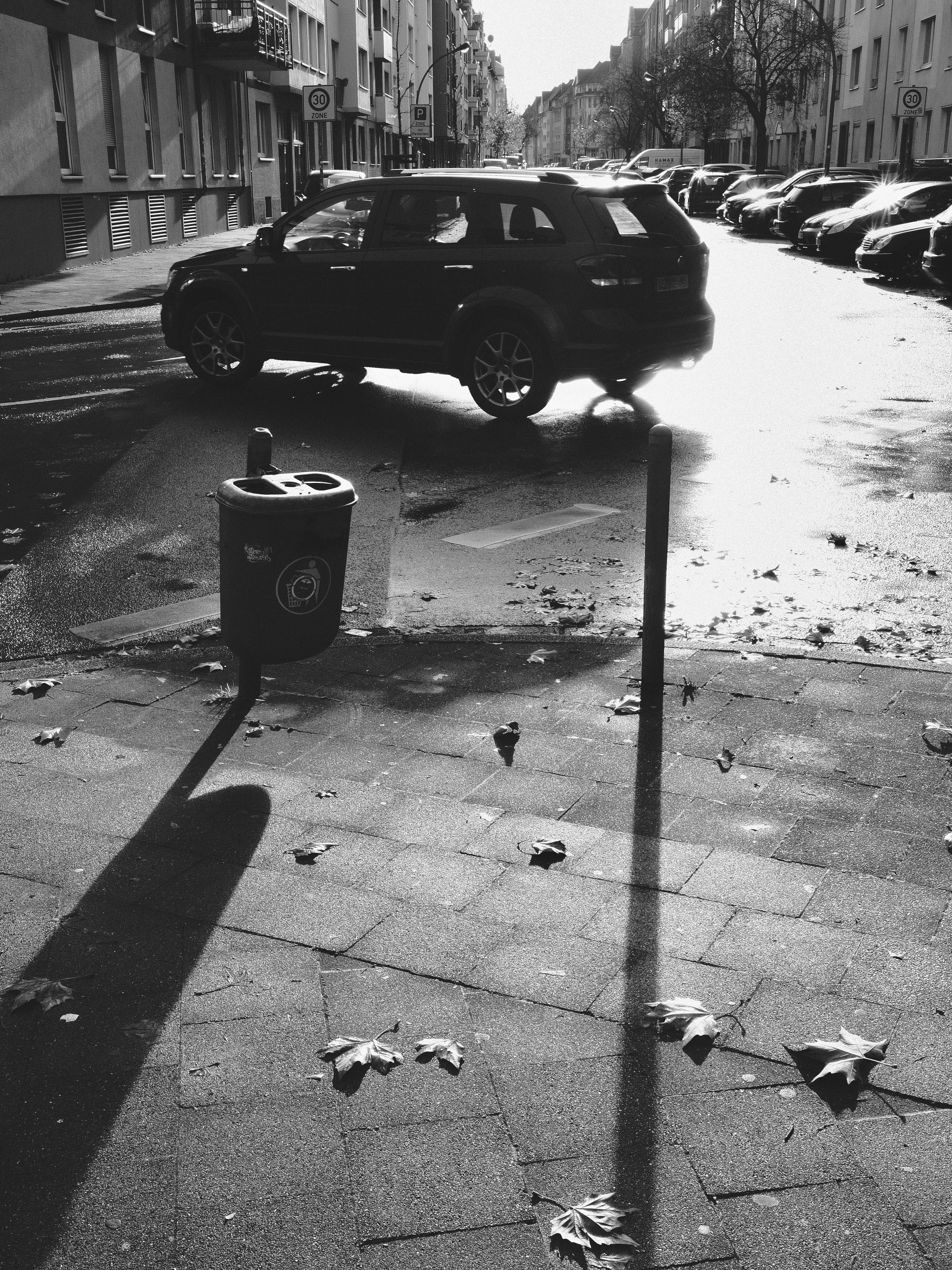 A car parked on a sunny city street.