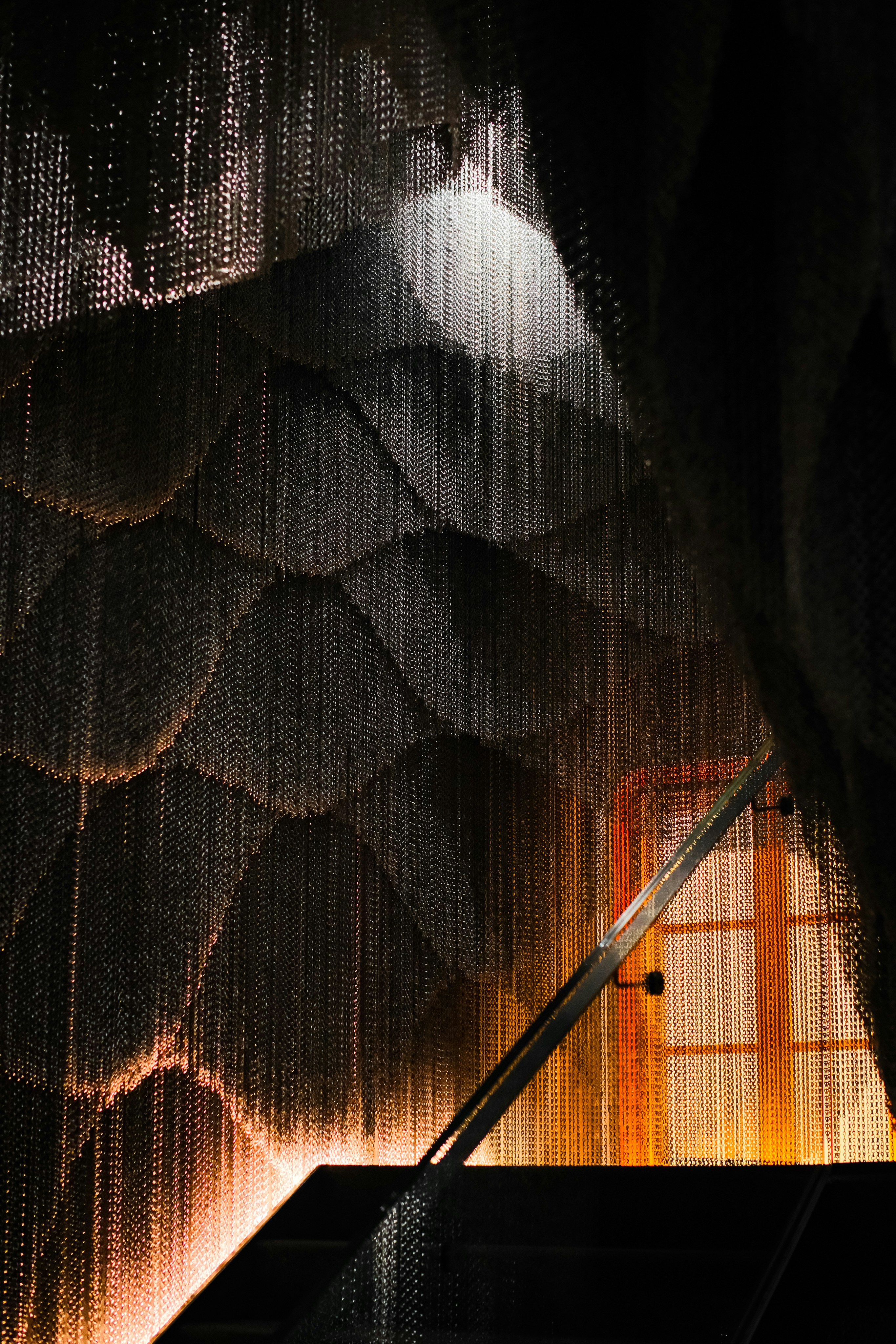 Modern interior with metallic chain curtain and scale-like wall