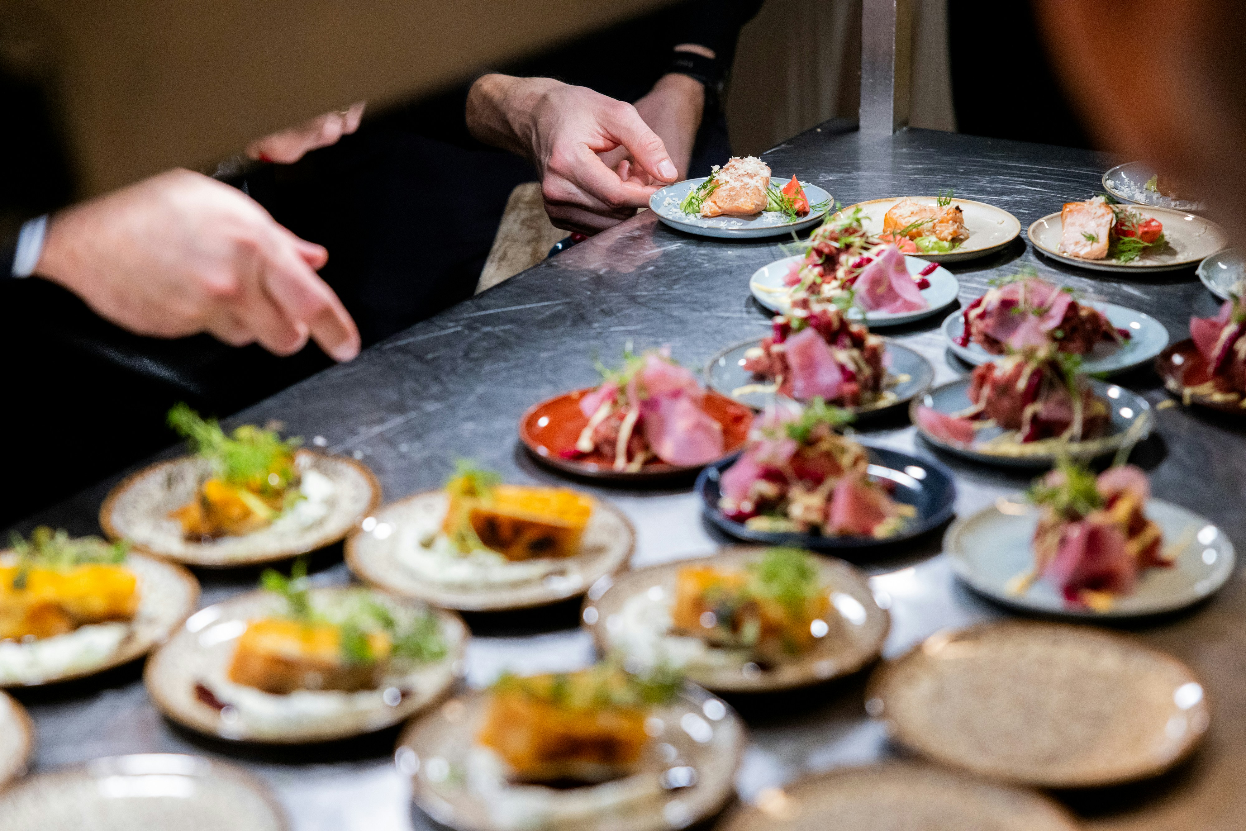 Chef arranging small plates of food