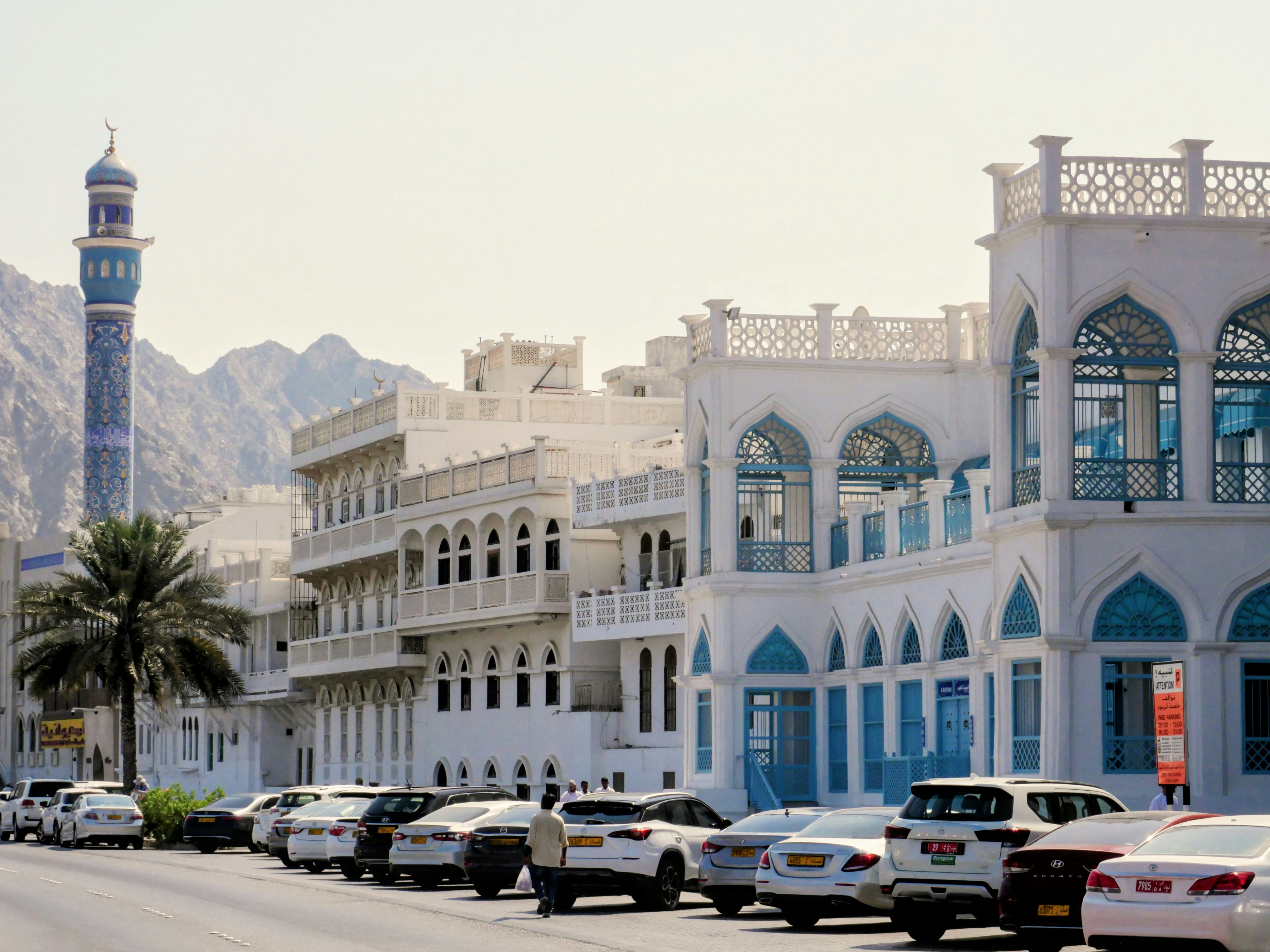 White buildings with blue accents and a minaret.