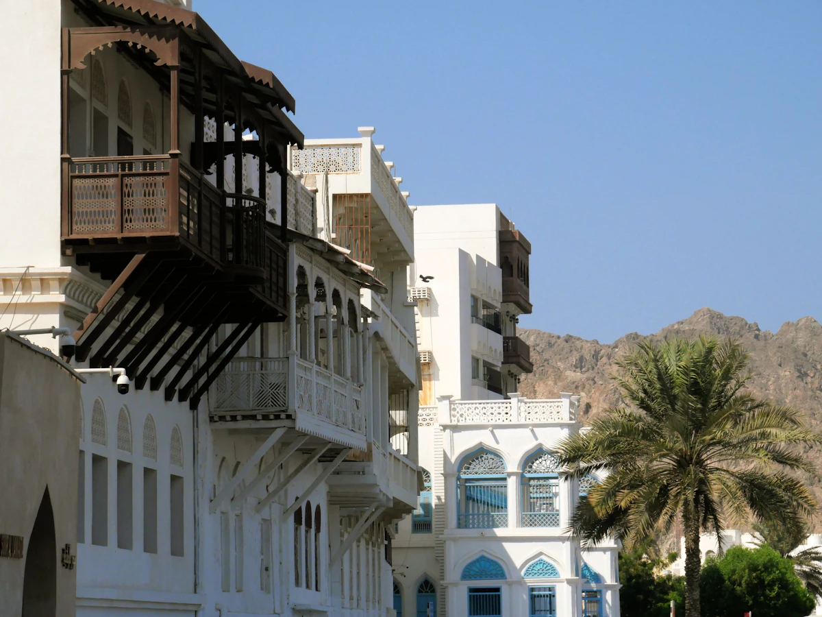 Traditional white buildings with timber balconies in Muttrah, Muscat