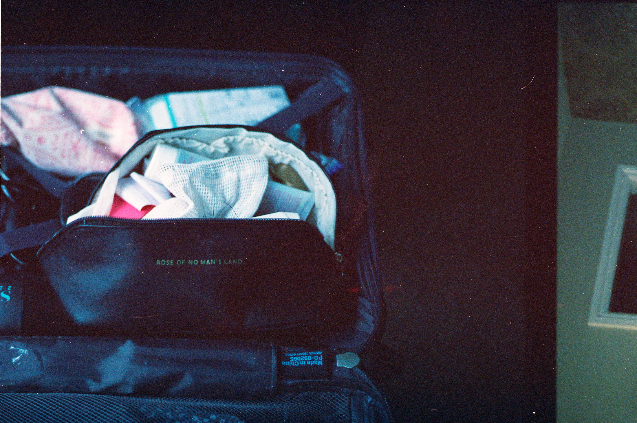 Open luggage organized with travel toiletries and packing accessories