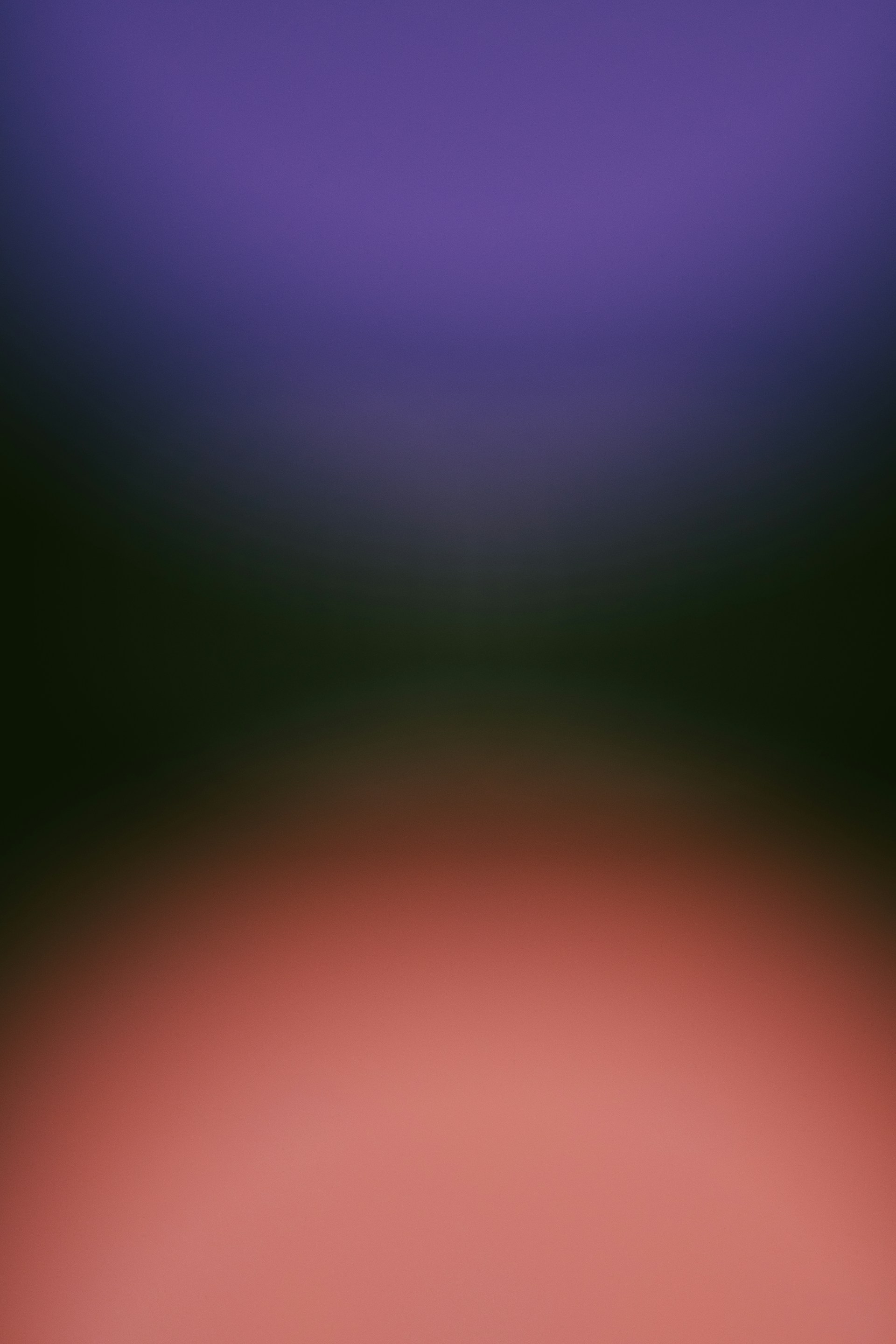 Abstract gradient of purple, green, and pink.