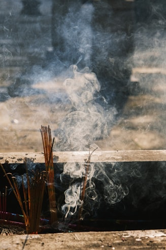 Incense sticks burning and smoking outdoors