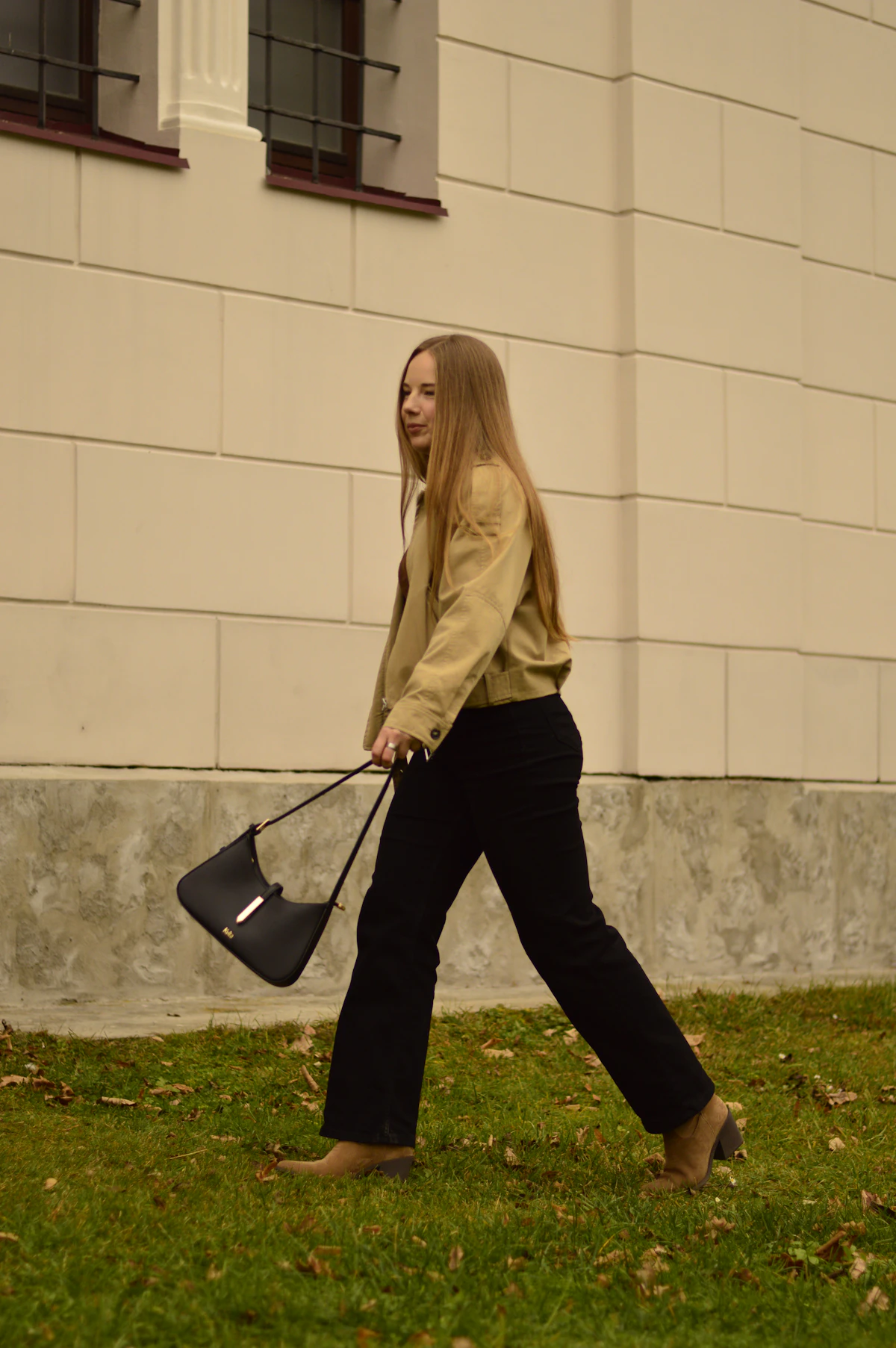 Woman walking outdoors with a handbag