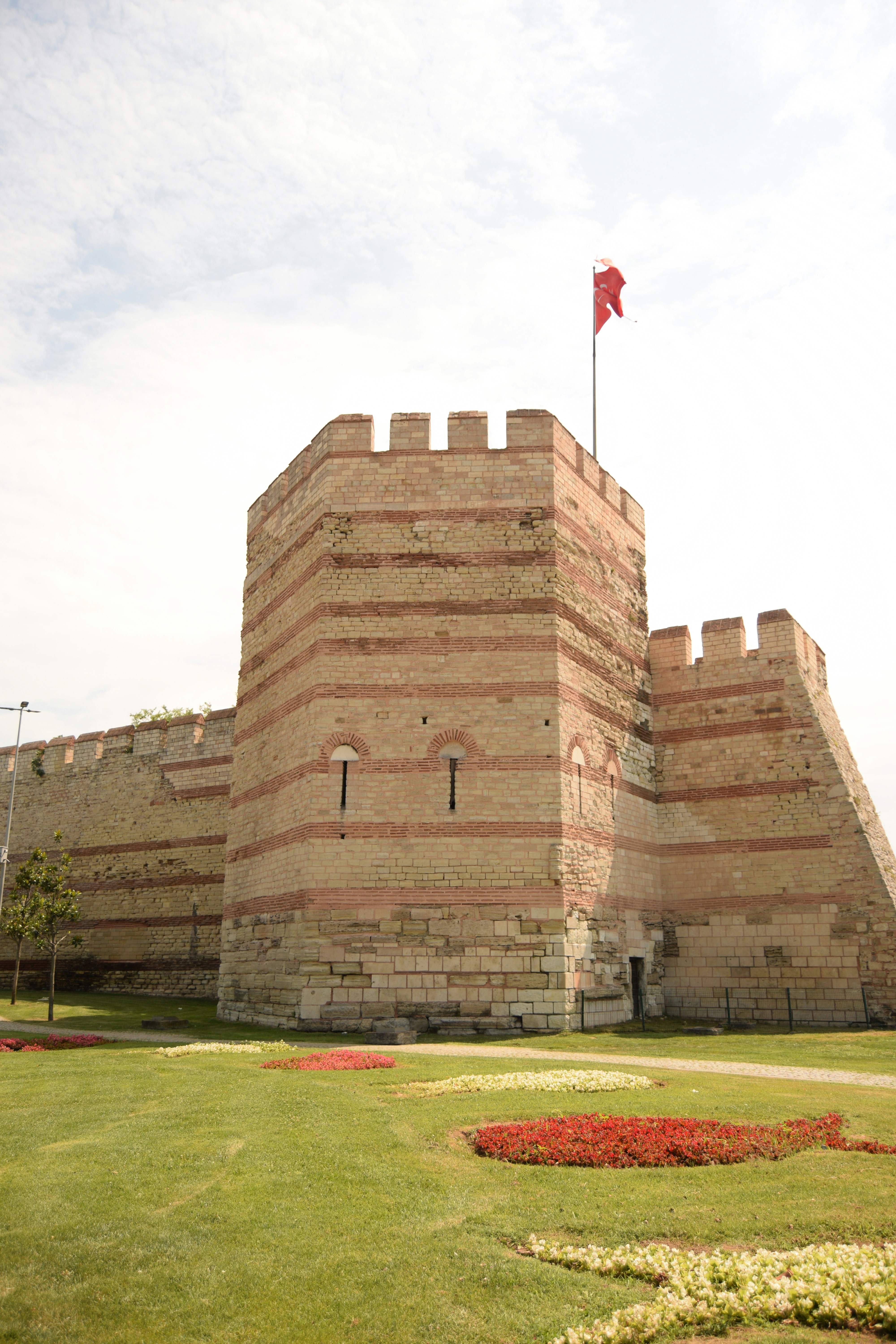 Ancient stone fortress with red flag flying high