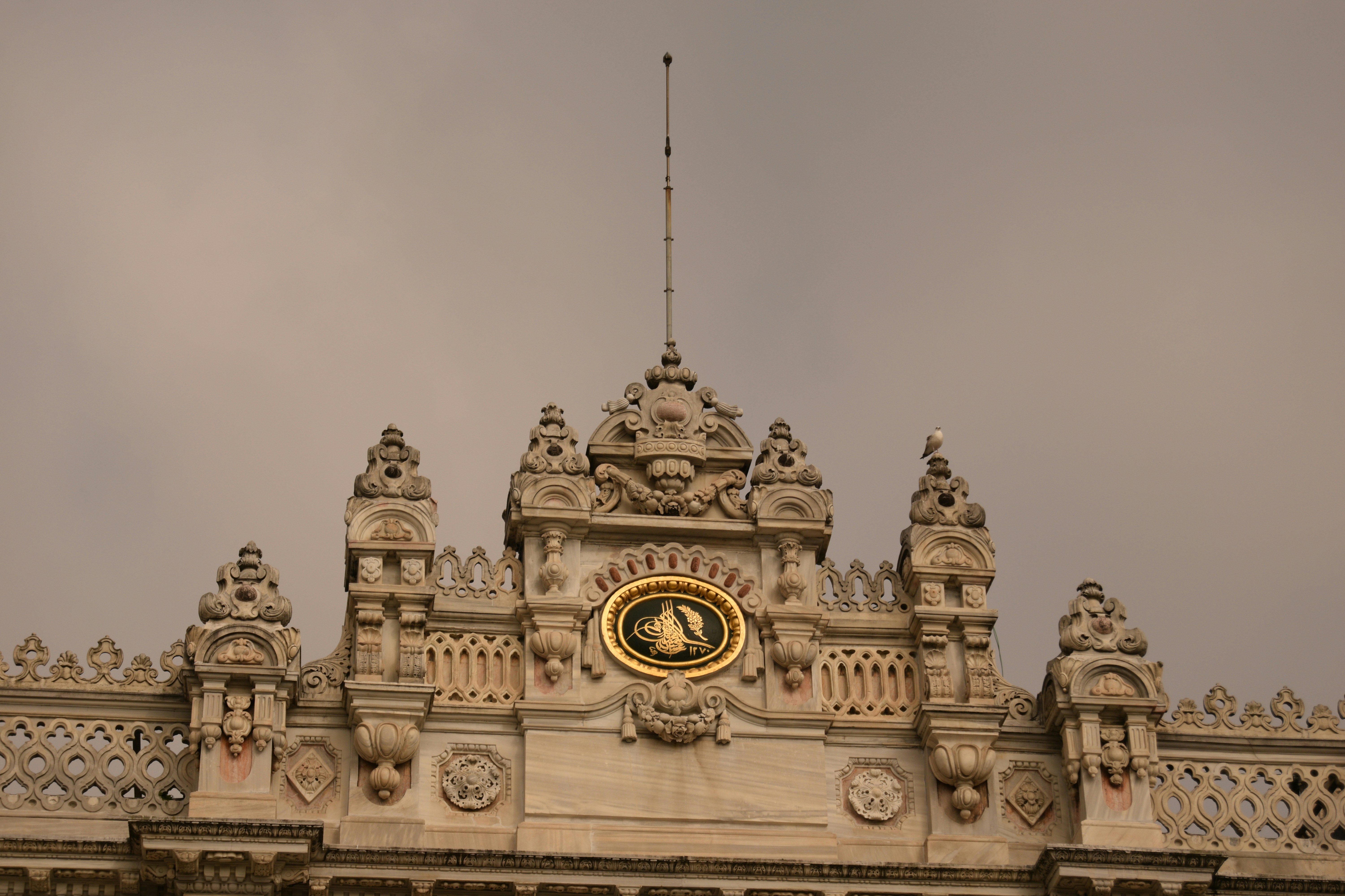 Ornate building facade with golden emblem